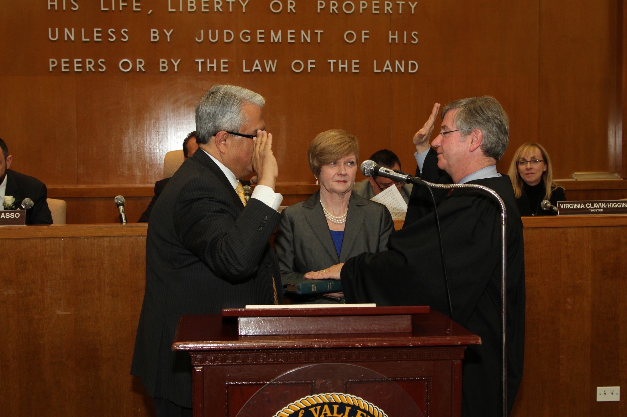 Village Justice Robert Bogle, right, was installed by Hempstead Town Councilman Anthony Santino. Bogle’s wife, Kathy, is behind them.