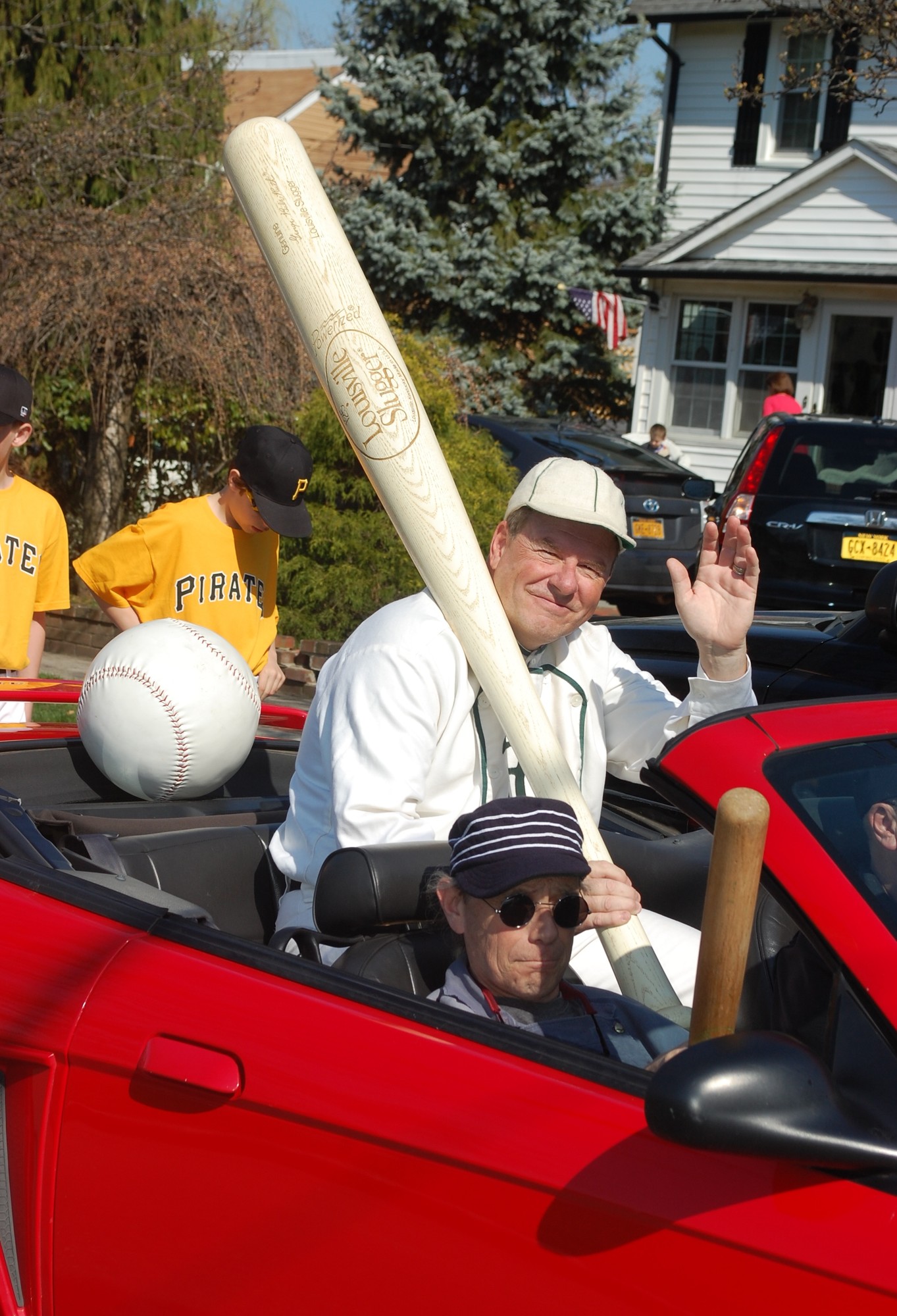 Ed Pecinka, of Wantagh, a member of the vintage Mutuals baseball team at the Old Bethpage Village Restoration, waved to the crowd on Demott Street.