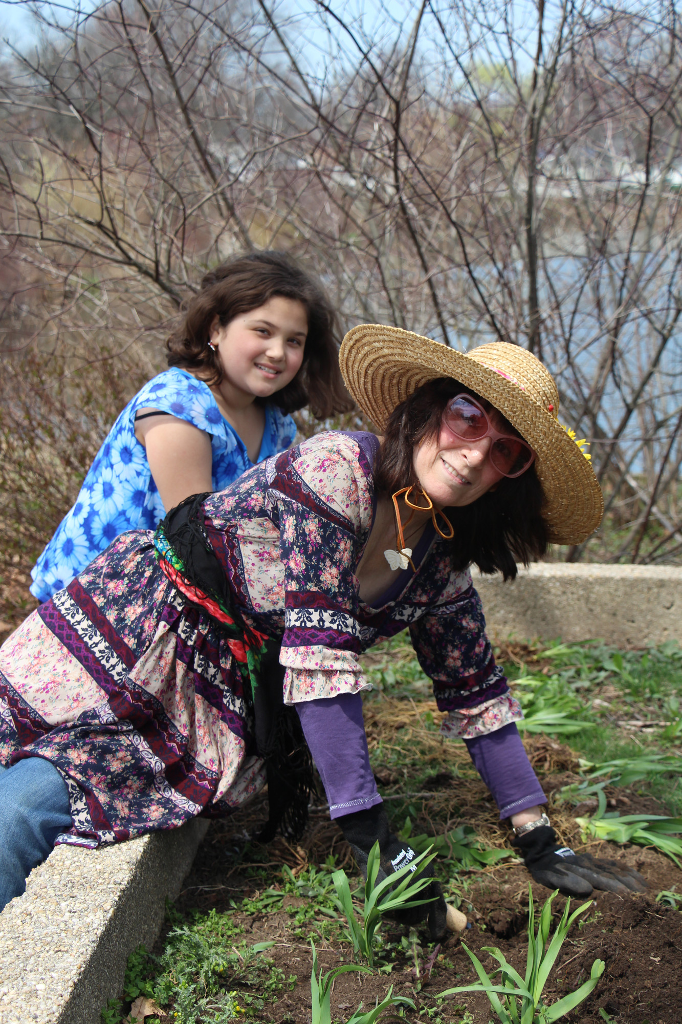Ariana Potamonsis, 9, and Lucille Musto planted some flowers in a garden at Lofts Pond Park.