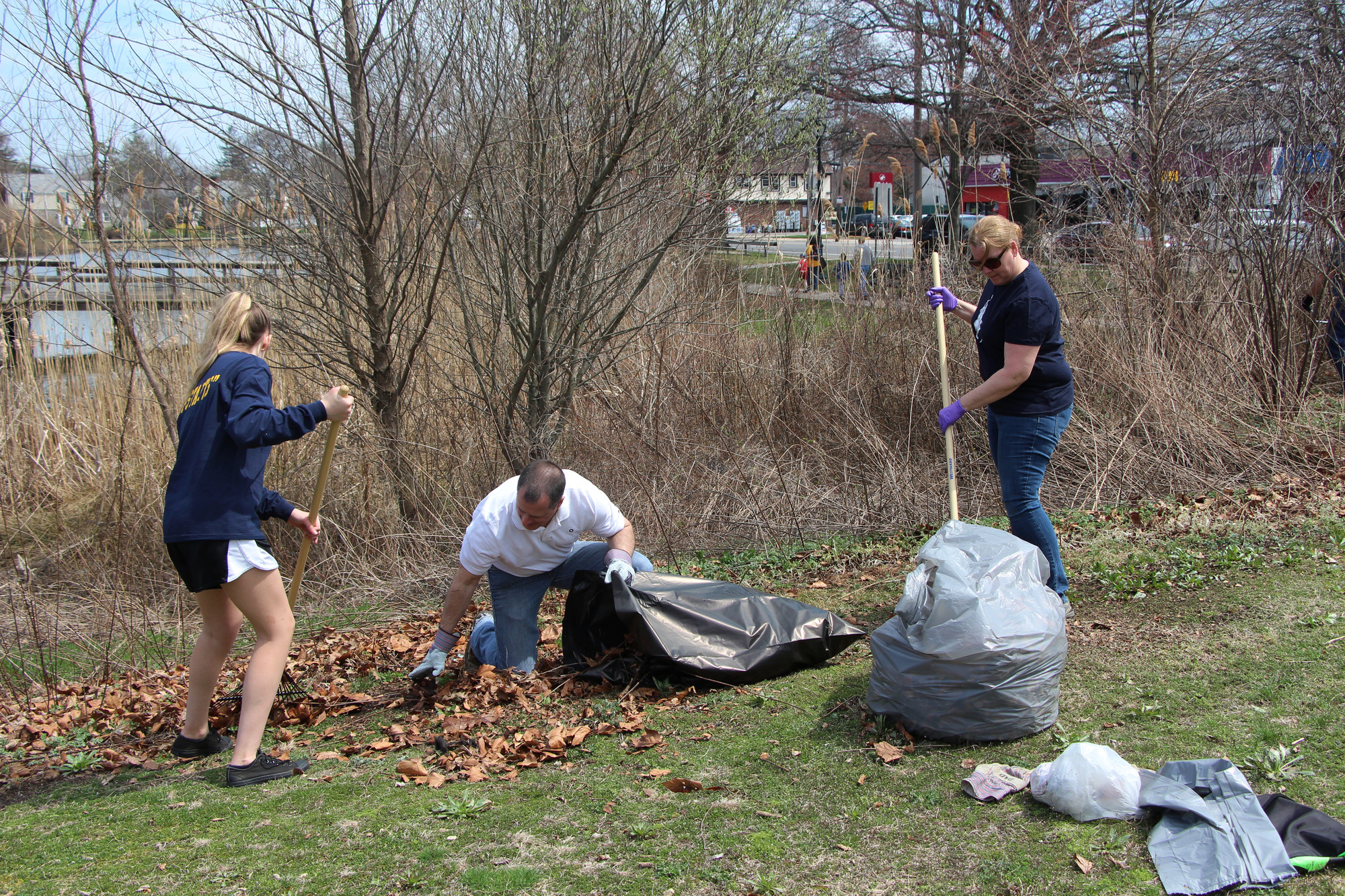 Many hands made light work at the cleanups over the weekend. Elizabeth Rattoballi, 16, left, and her mother Rosemary got some assistance from Assemblyman Brian Curran.