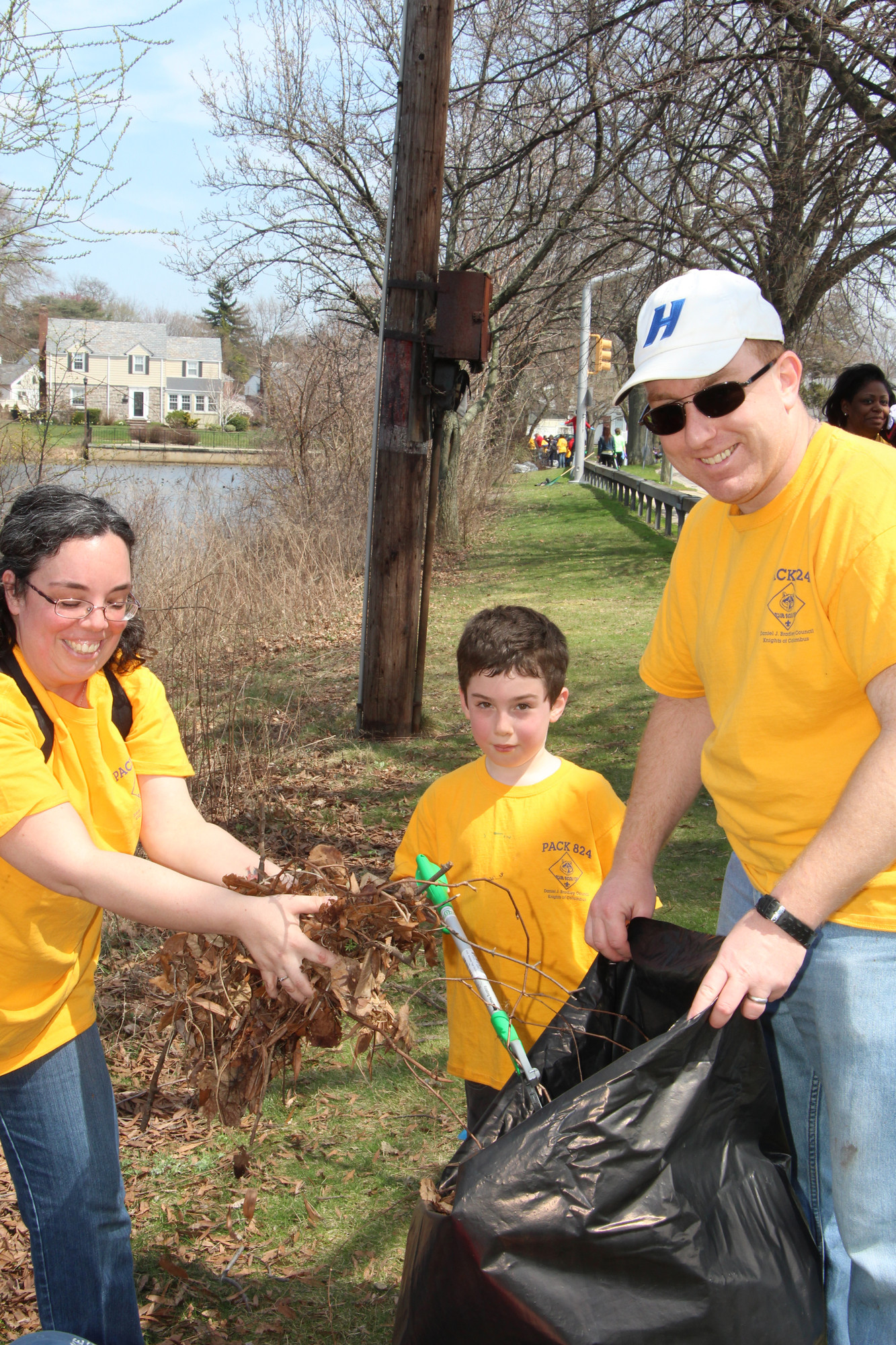 Theo Walsh, of Cub Scout Pack 824, with help from his parents Valerie and Matthew, picked up a lot of garbage and leaves at Lofts Pond Park last Saturday during an Earth Day cleanup.