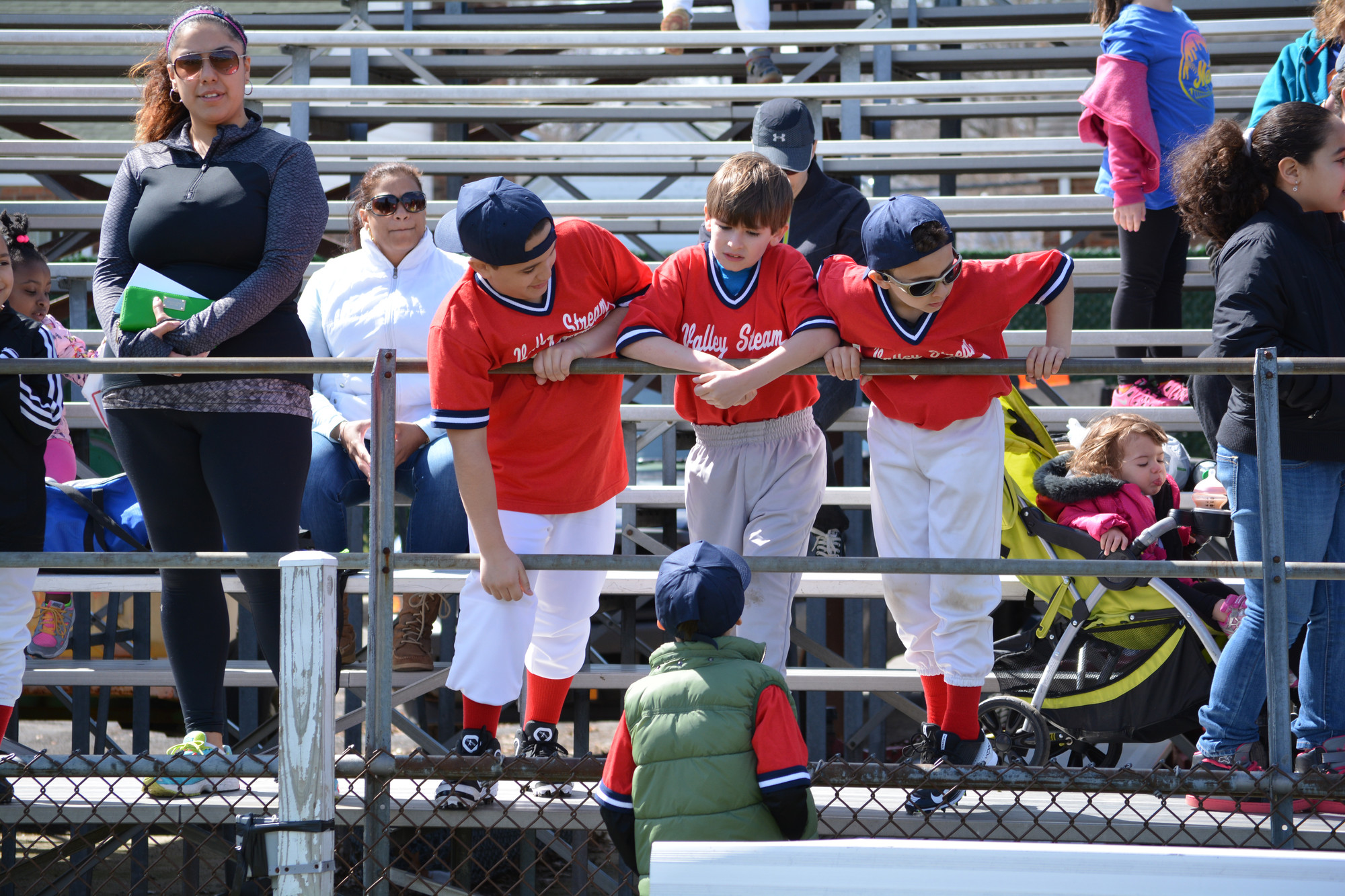 Little Leaguers chat as they wait for the opening day ceremonies to begin at Firemen’s Field on April 11.