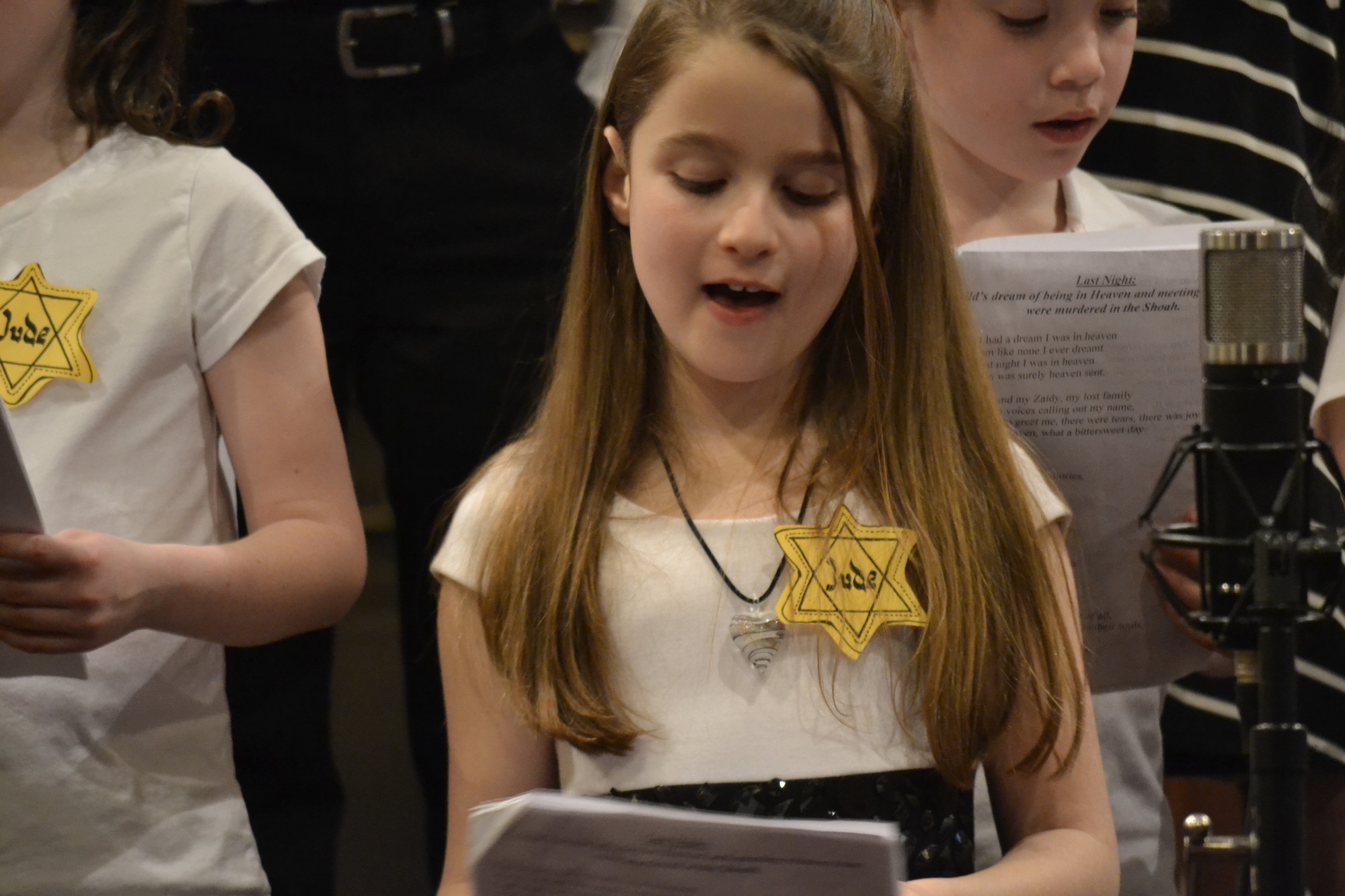 Student participation was an essential part of local services. Above, Rebecca Silverman, of EMJC’s Hebrew School chorus, sang to hundreds in attendance.