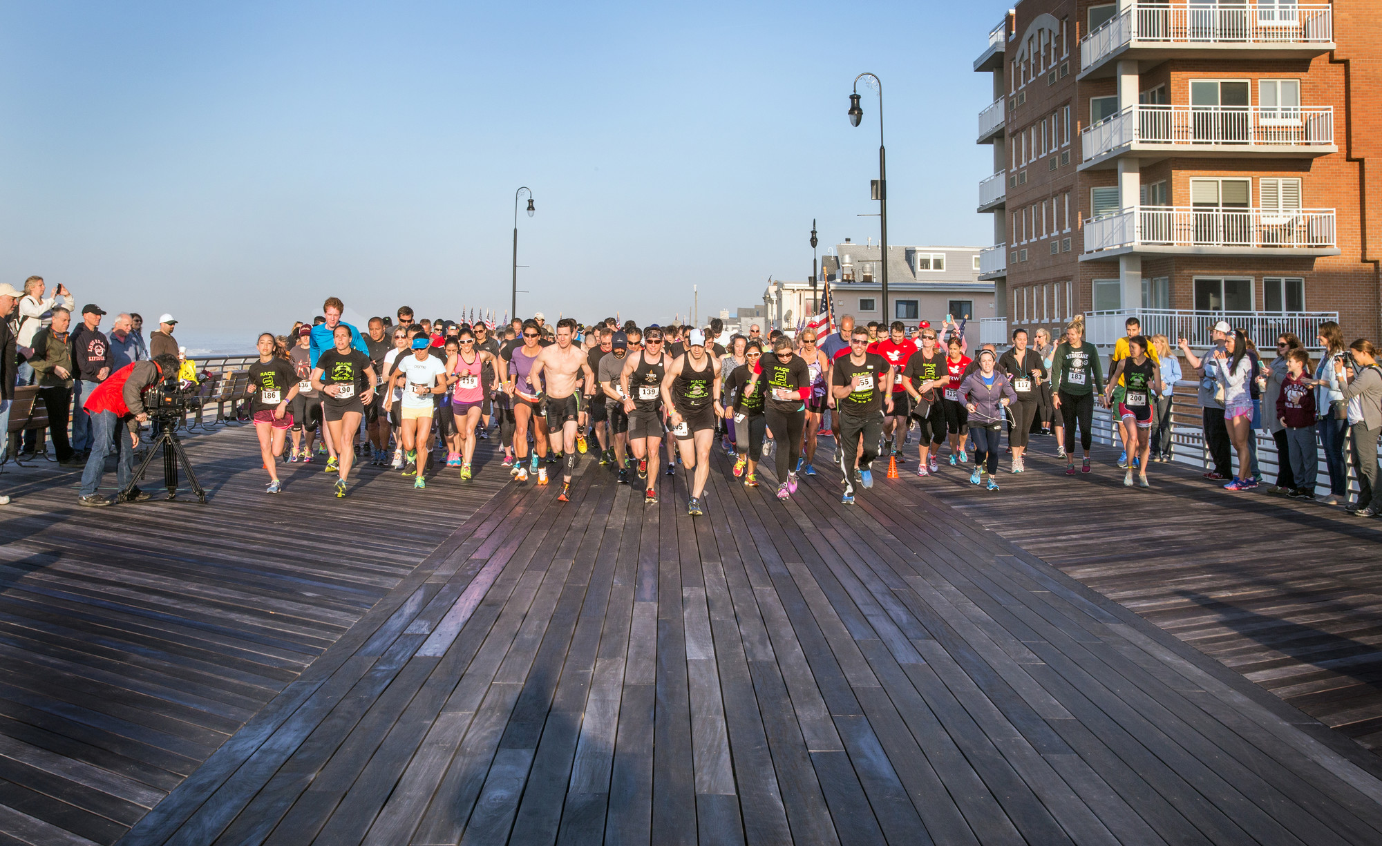 Hundreds of runners lined up on the boardwalk at the start of last Saturday’s Run, Ride, Rebuild event, a 5K and duathlon, whose participants helped raise money for storm relief efforts and volunteered to rebuild the homes of two Long Beach residents.
