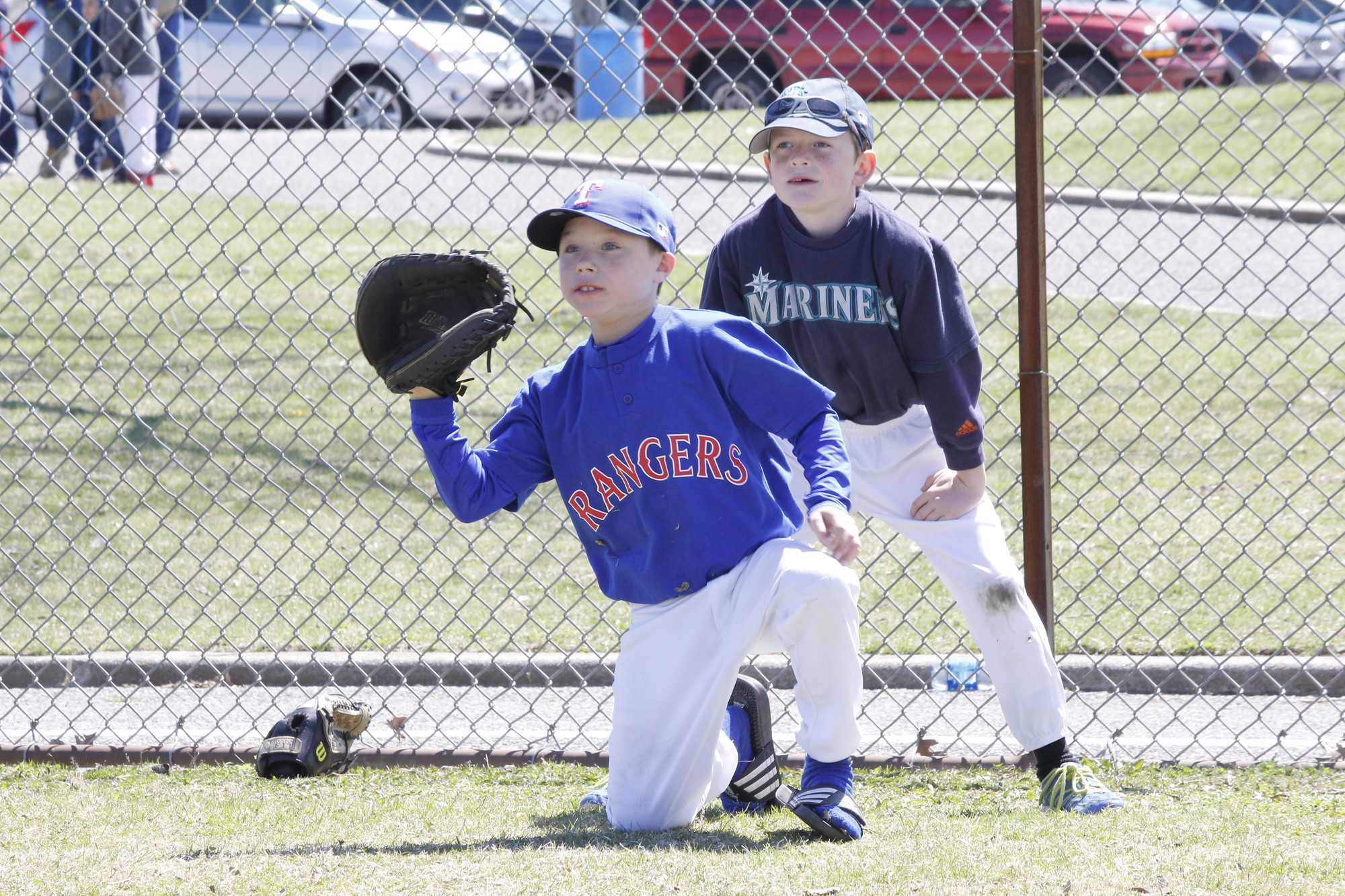 Michael Jazylo, of the Rangers, practiced catching while Logan Kirchner, of the Mariners, played the role of umpire.