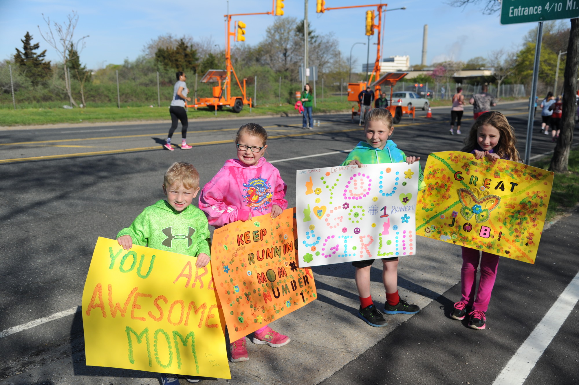 Christopher Reslaff, 4, at left, Claudia, 6, Emilia, 9, and Katie Malcomson, 8, cheered on their mom and aunt.