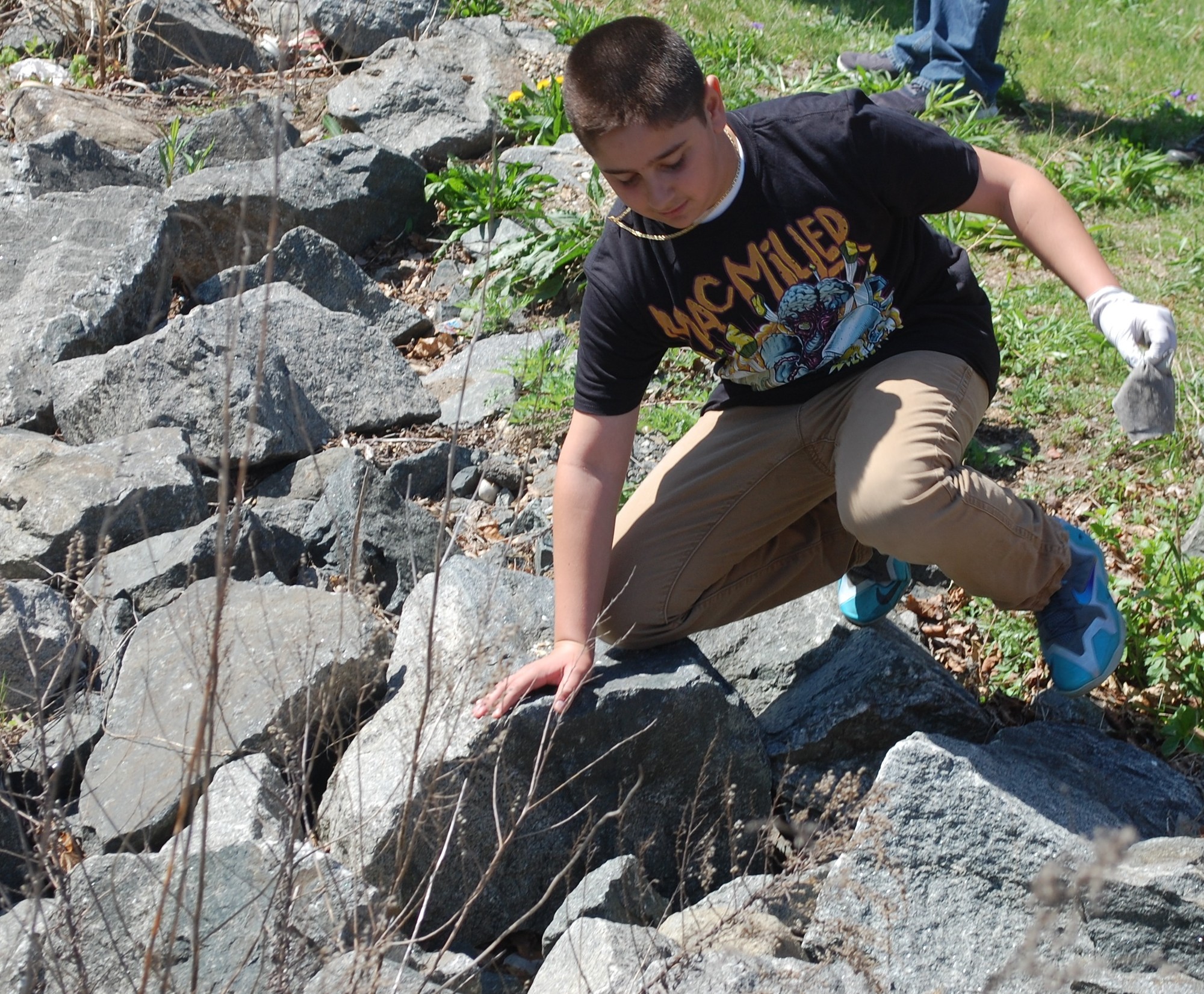 Vinny Tudisco scaled the rocks to collect garbage.