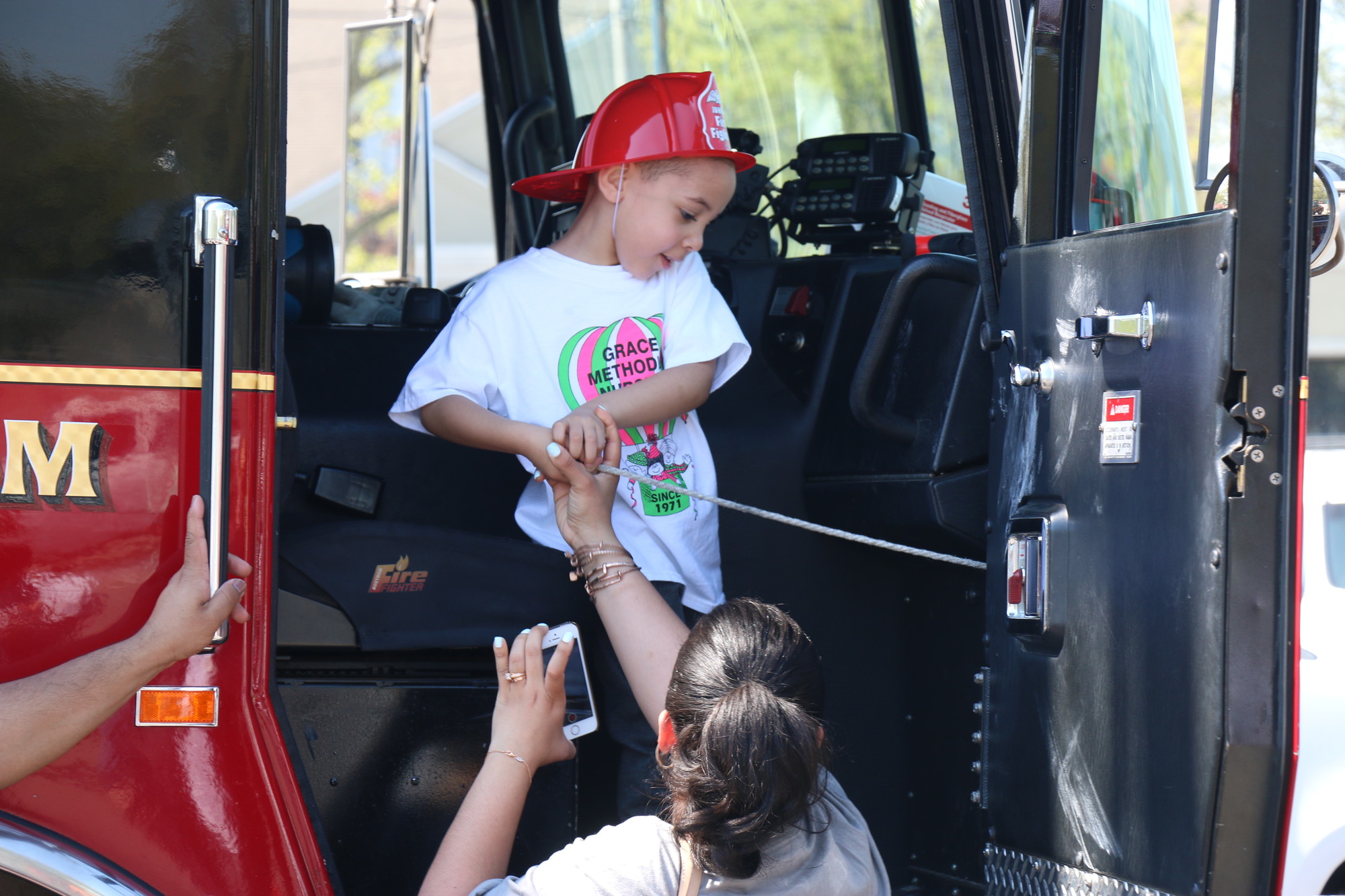 Getting some help ringing a fire truck’s bell was Jayden Aponte, 4, whose mom, Jeanette, showed him the ropes.