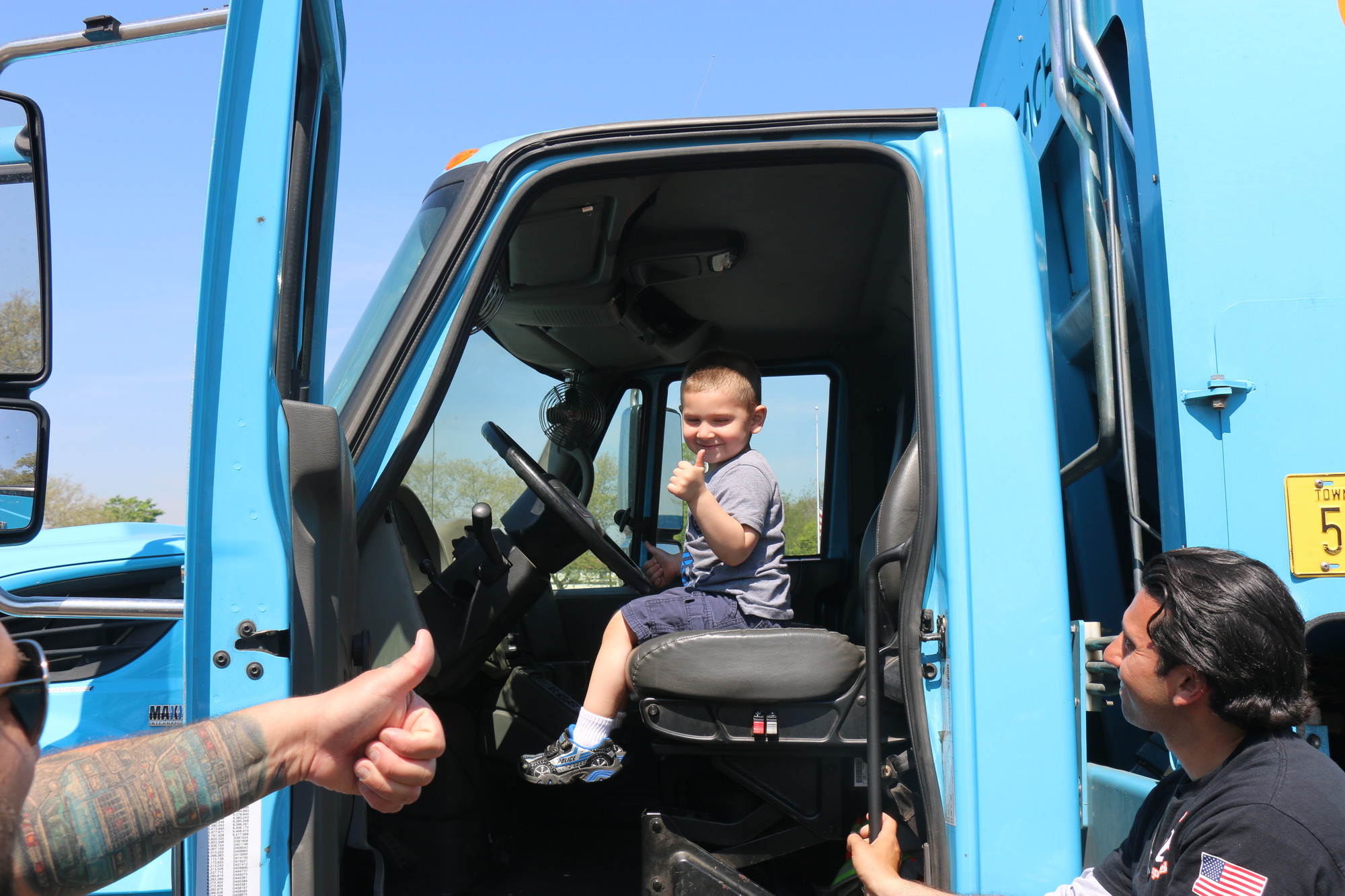 Alex Scarangella, 3, enjoyed sitting in the driver’s seat of a village truck. Its horn was a popular feature among the kids.