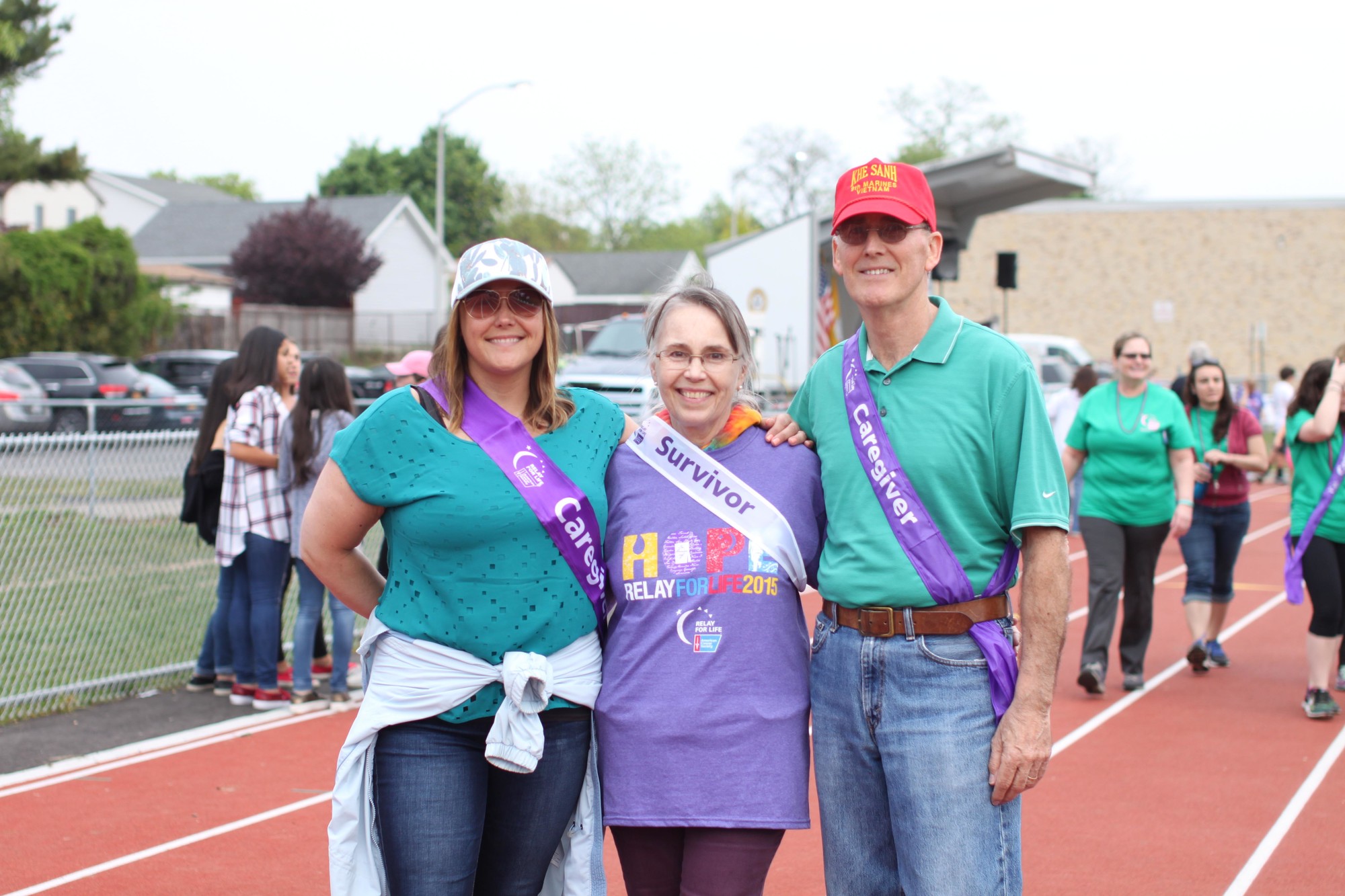 Lynn Slattery, survivor, poses for a picture with her husband Robert and daughter Heather after completing the caregiver lap.