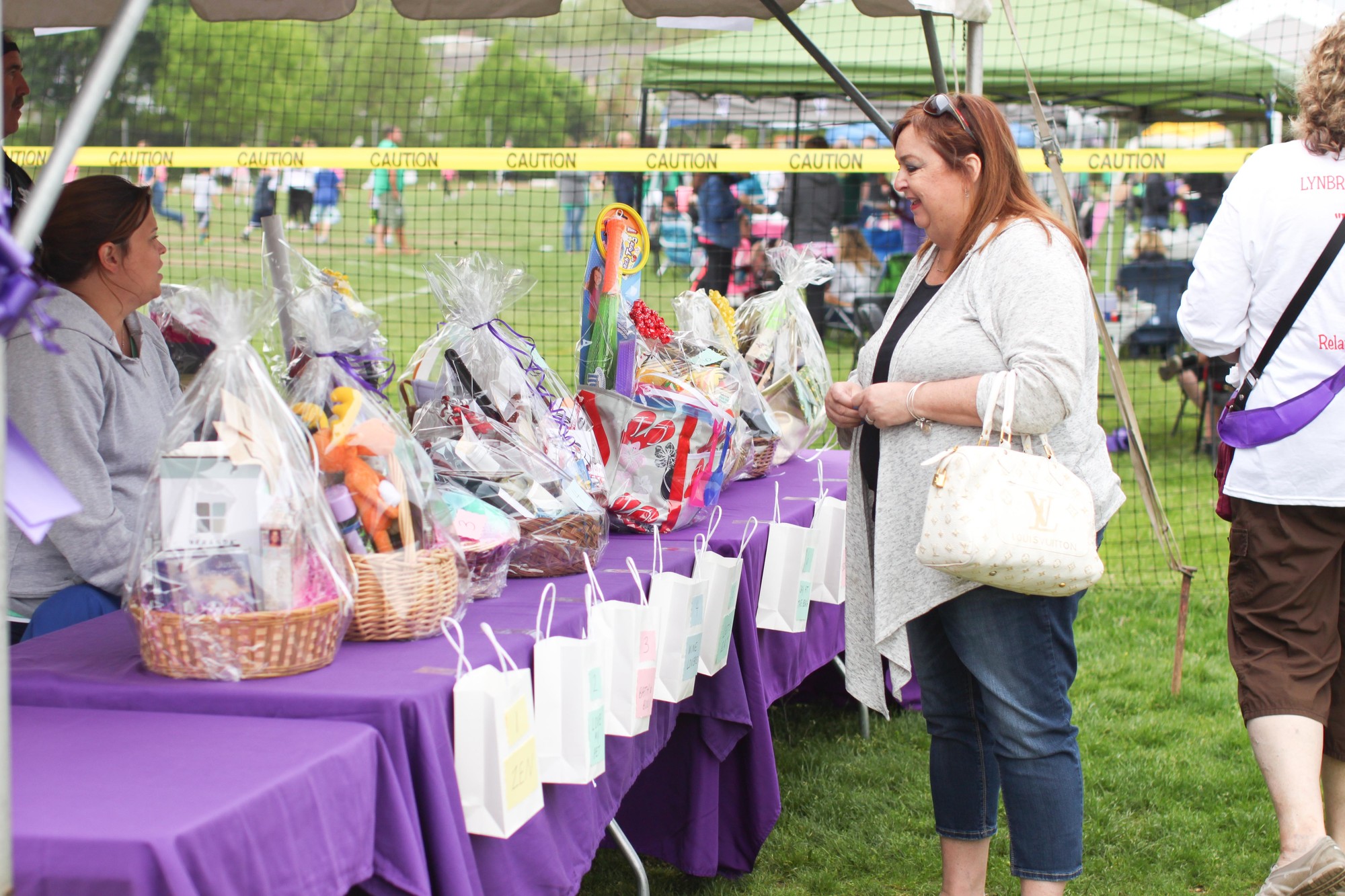 Roseanne Strife browses the raffle baskets before placing her ticket.
