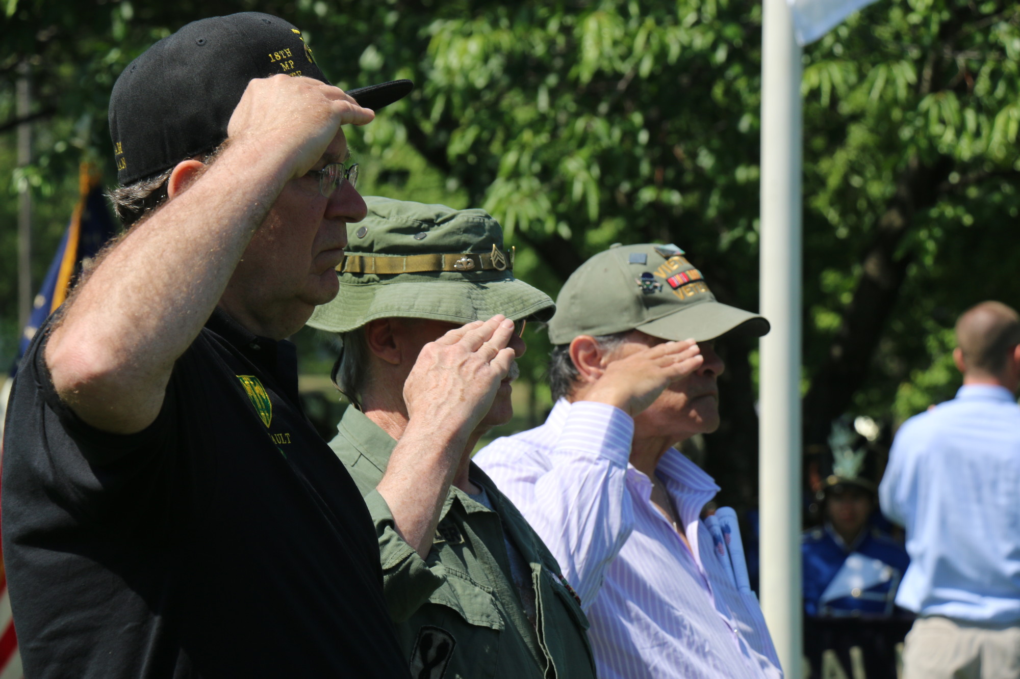 Vietnam veterans John Filiault, left, and William Hunter, far right, salute during the ceremony.