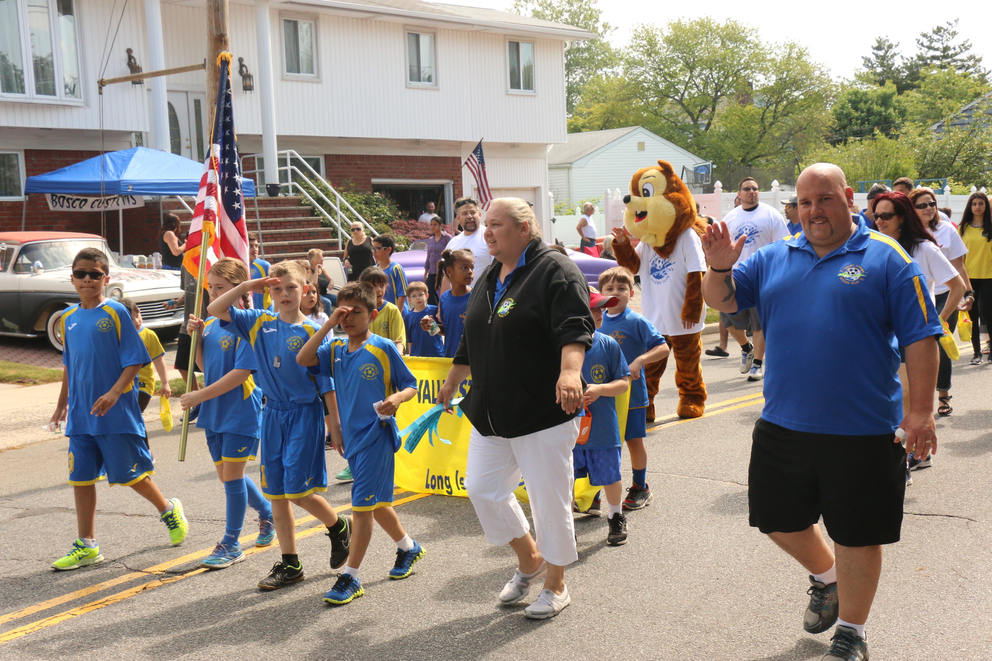 Valley Stream Soccer Club President Timothy Graham, right, and his wife, Jennifer, center, led the club in the parade.
