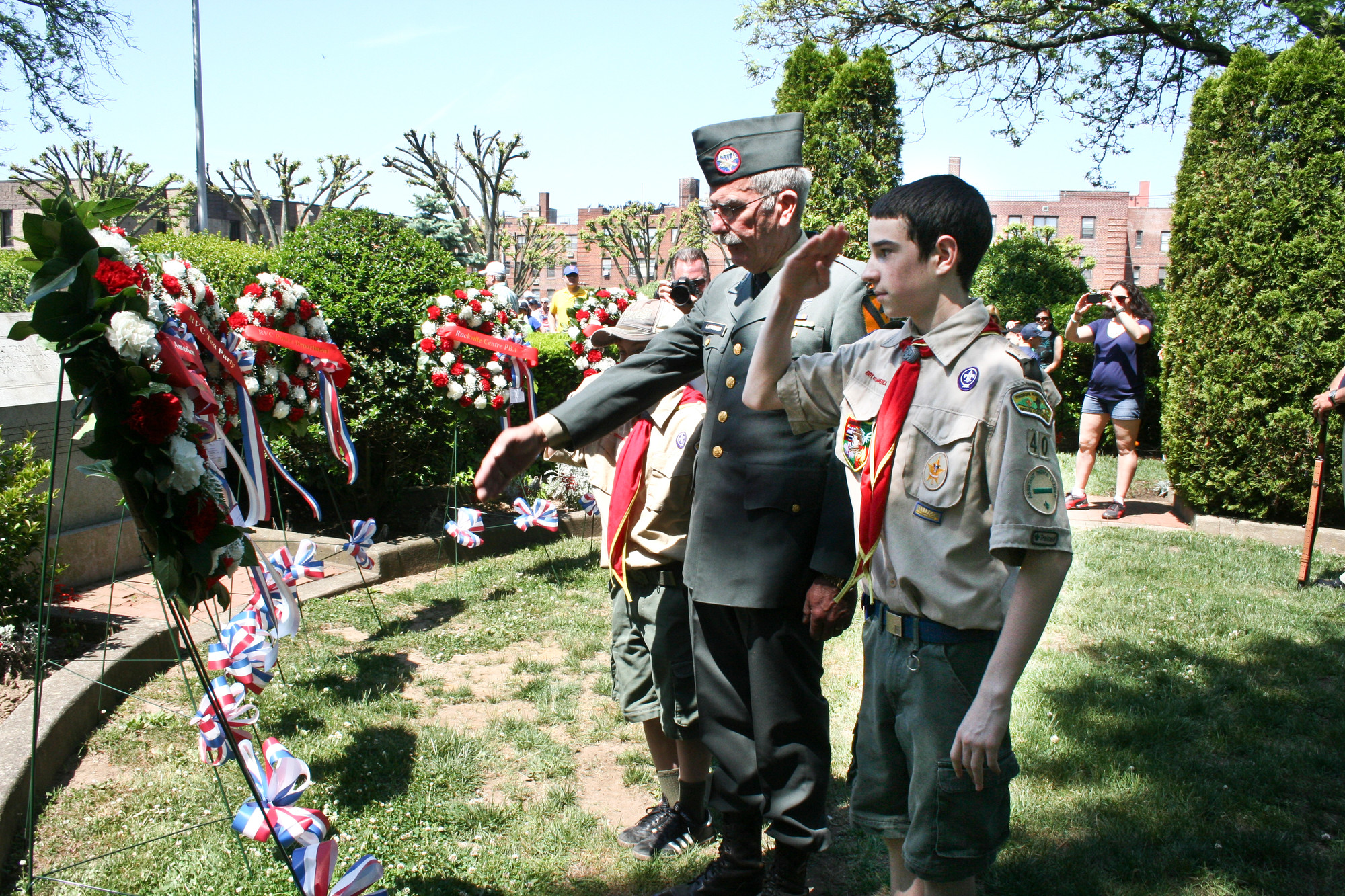 Veteran Michael Lapkowski helped local Boy Scouts place a wreath on the village’s memorial.
