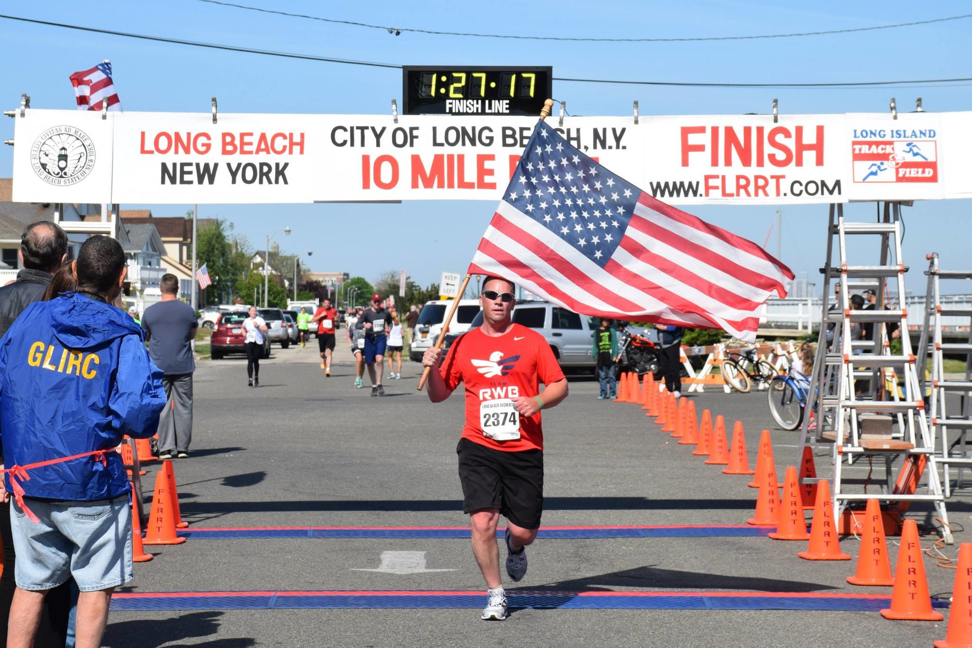 Keith Grant, founder of 1156Run and a veteran, crossed the finish line carrying an American Flag.