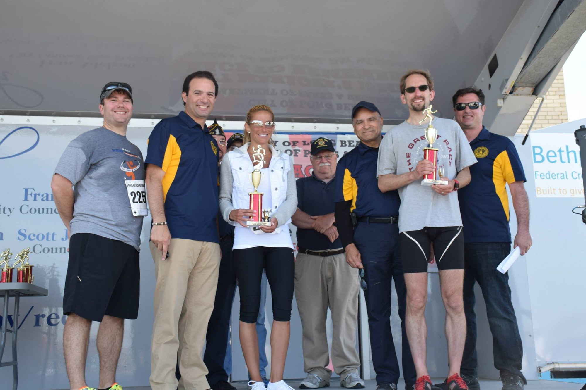 City Manager Jack Schnirman, left, City Councilman Anthony Eramo, first-place women’s finisher Melissa Moschetto, VFW Commander Dan MacPhee, Council President Len Torres, first-place men’s finisher Aaron Robertson and Assistant Superintendent of Parks and Recreation Paul Ferrante.