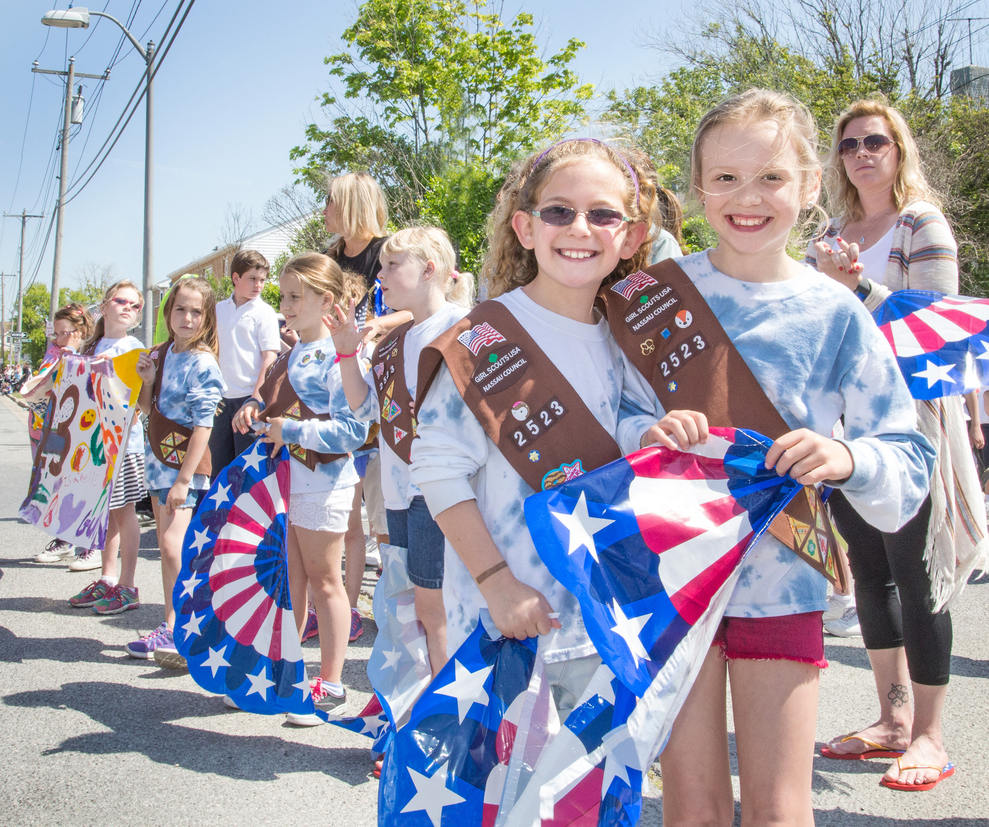 Maggie Keating, left, 8, and Anna Pagan, 8, from Brownies Troop 2523 cheered as the Veterans passed by.