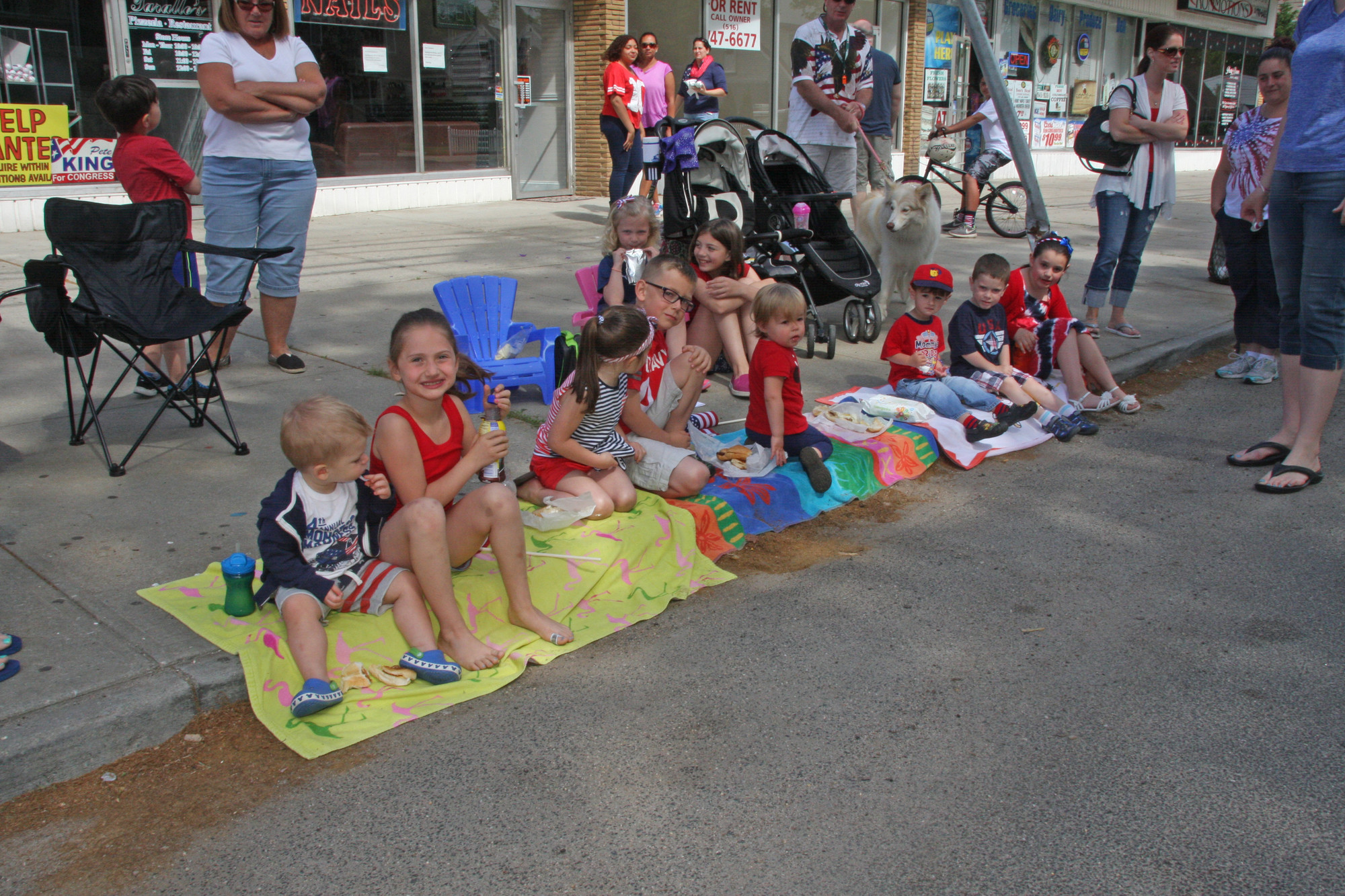 Children sat along Washington Avenue to watch the parade.