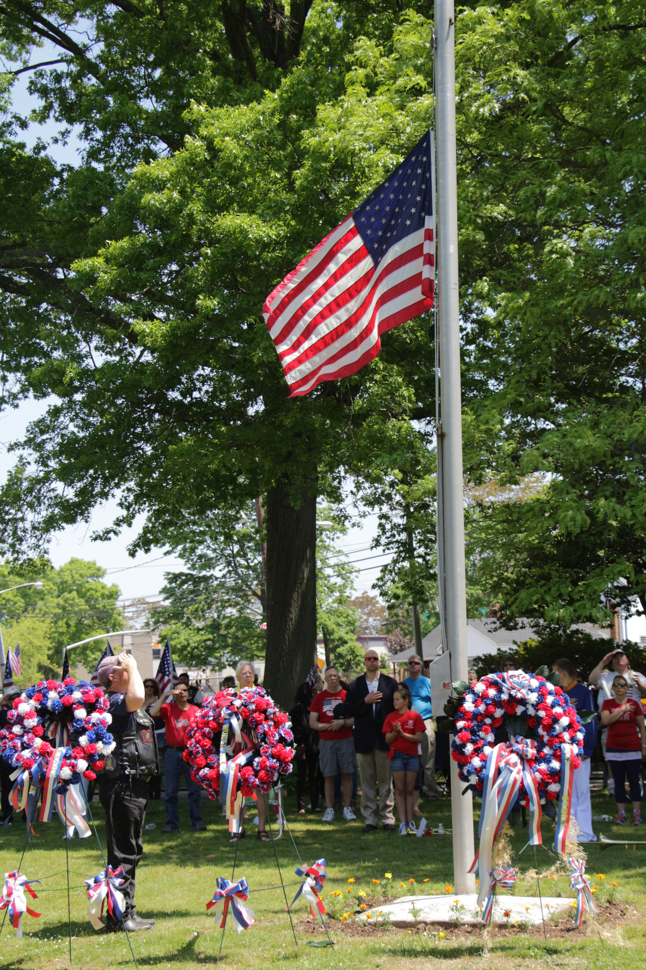 Hundreds of residents honored those who made the ultimate sacrifice on May 25 during the Memorial Day Parade down Grand Avenue and ceremony in Silver Lake Park. Peter Winninger, of the Forsaken Guns Motorcycle Club, saluted the flag.