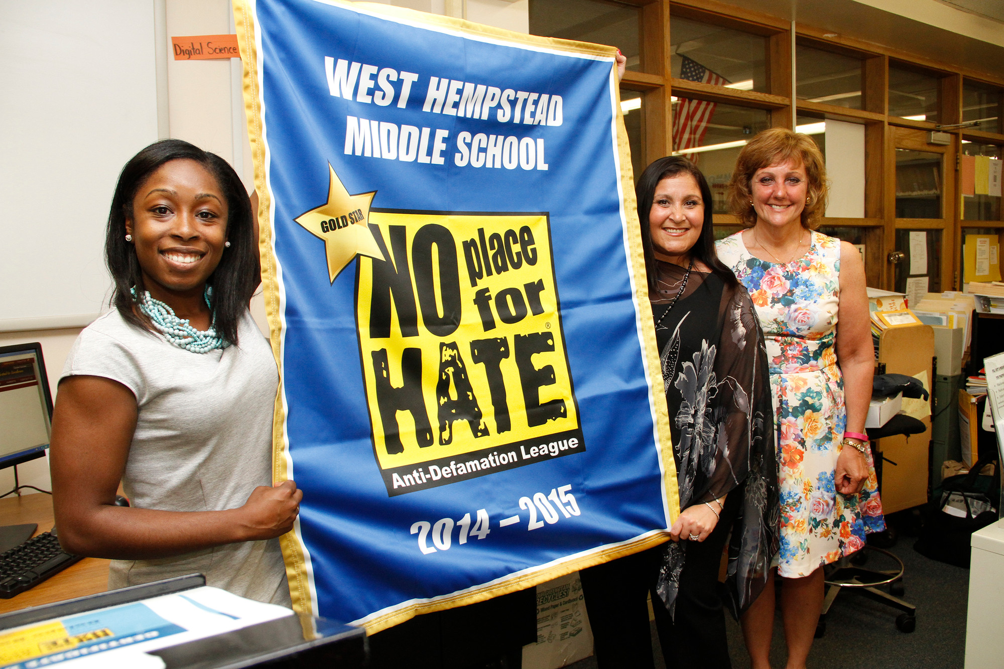 Amanda Holder, Cari Lubliner and Principal Teresa Grossane with West Hempstead Middle School's newly-aquired No Place for Hate banner from the Anti-Defamation League.