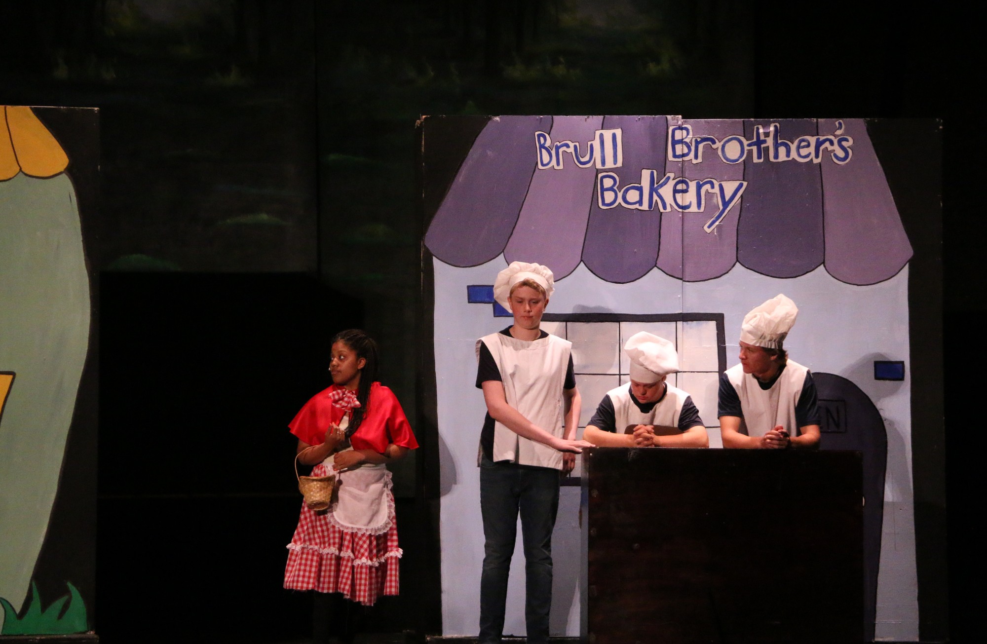 Little Red Riding Hood, played by Tazhane Griffiths, at the Brull Brothers Bakery with Alex Johnson (Tommy Brull), left, Danny Collins (Jack Brull) and Connor Griffin (Martin Brull).