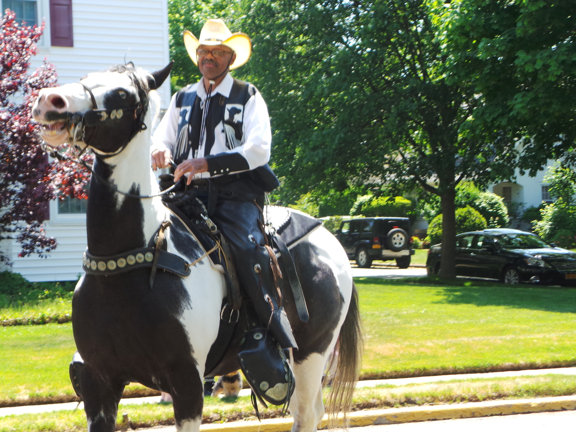 R.W. “Curly” Hall, from the Federation of Black Cowboys, makes his way down Hempstead Ave. during Malverne’s Memorial Day parade.