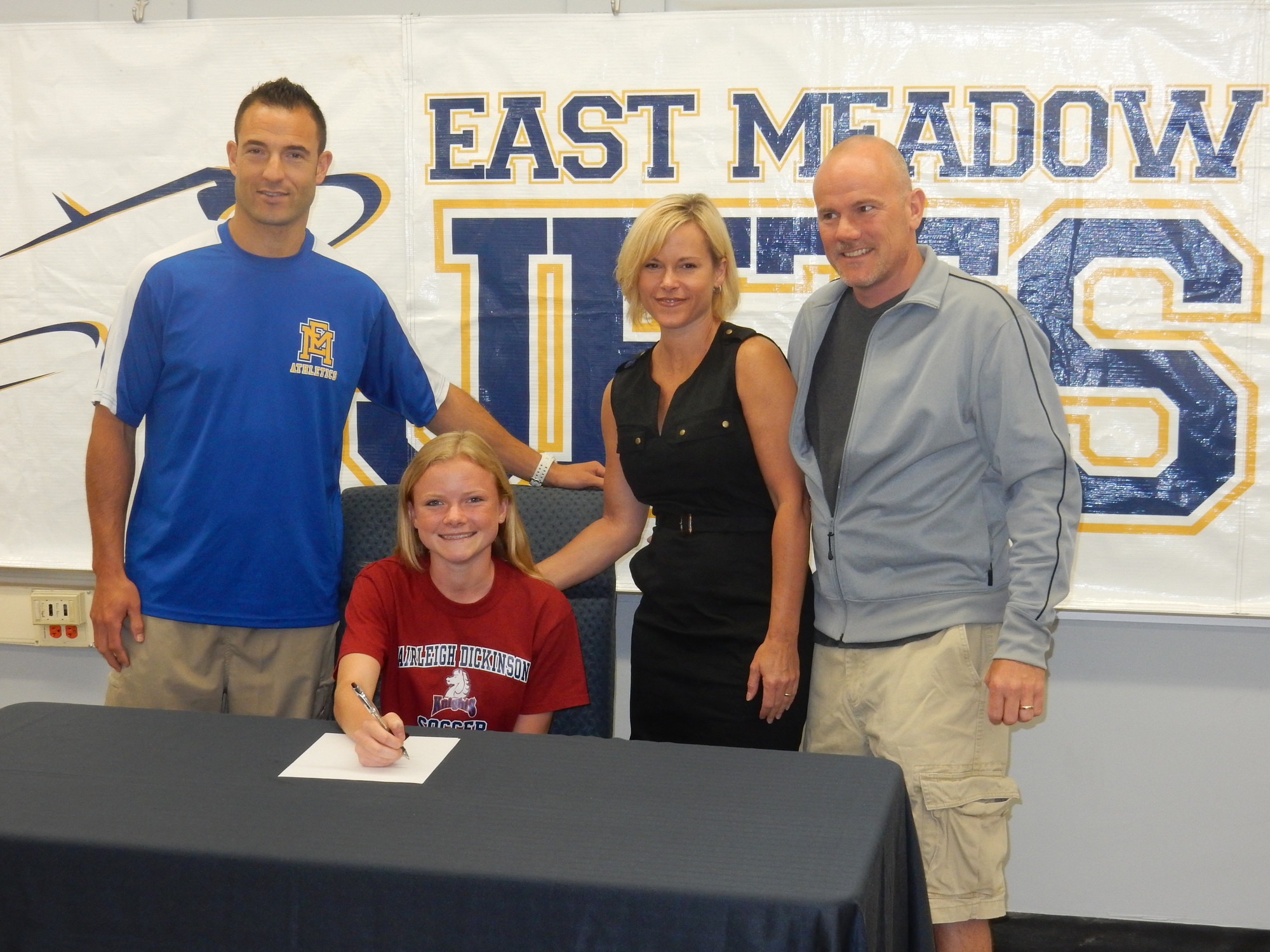 Nicole Keicher, surrounded by her soccer coach, Adam Hananel, left, and parents Jennifer and Wayne, will play soccer at Fairleigh Dickinson University.