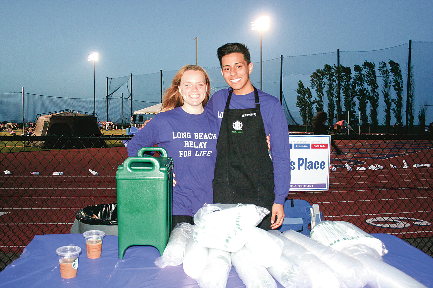 Demi Amideneau and Sebastian Vidao gave out iced coffee from Starbucks to keep runners and walkers going all night.