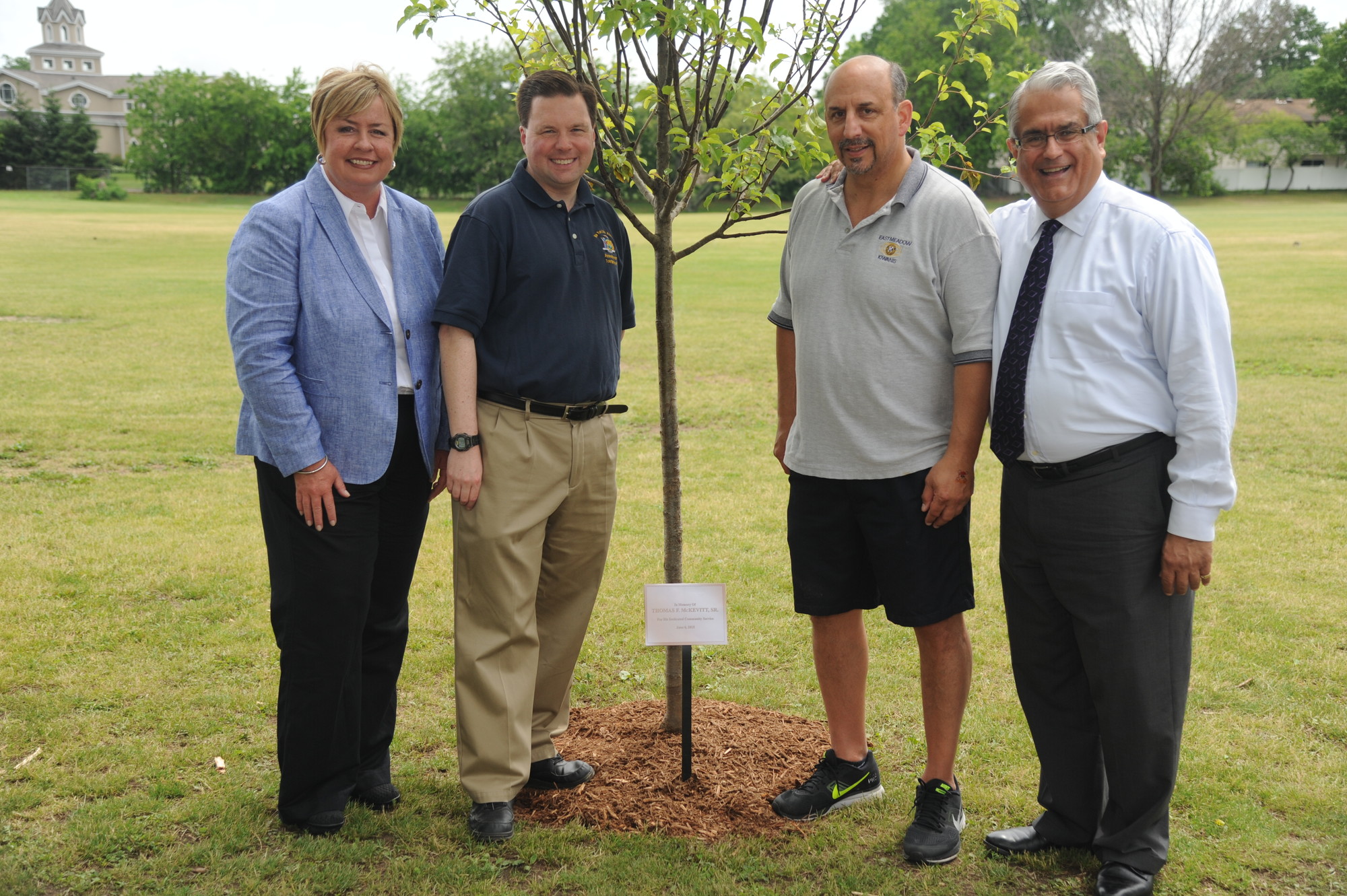 A tree was planted in honor of Thomas McKevitt, Sr., a longtime community activist who died last June. Standing near the memorial was his son, State Assemblyman Tom McKevitt, second from left, Pride Day co-chairman Alan Beinhacker, second from right, and Town of Hempstead Supervisor Kate Murray and Councilman Anthony Santino.