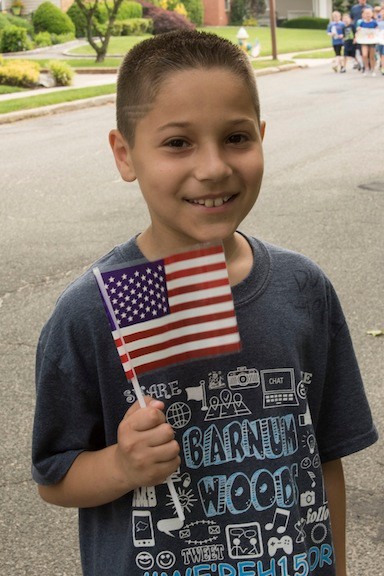 Angelo Tsassis helped lead the Pledge of Allegiance during the pre-walk ceremony.