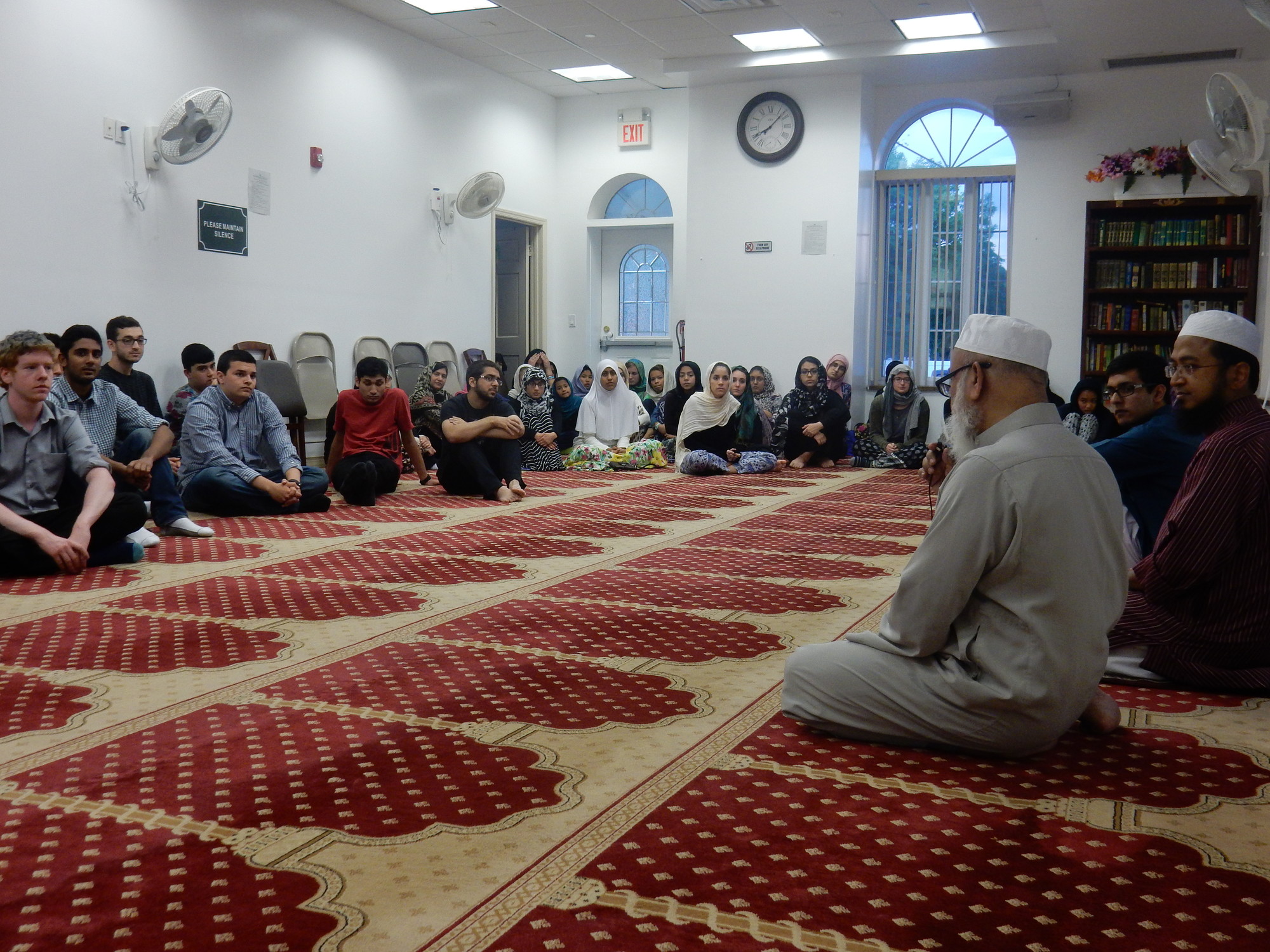 More than 60 local students gathered on June 22 at the Long Islamic Muslim Society to learn about Islam. At near right were spiritual leaders Kamal Ahmed, left, his son, Imam Hamadullah Kamal, and student Ayyan Zubair.
