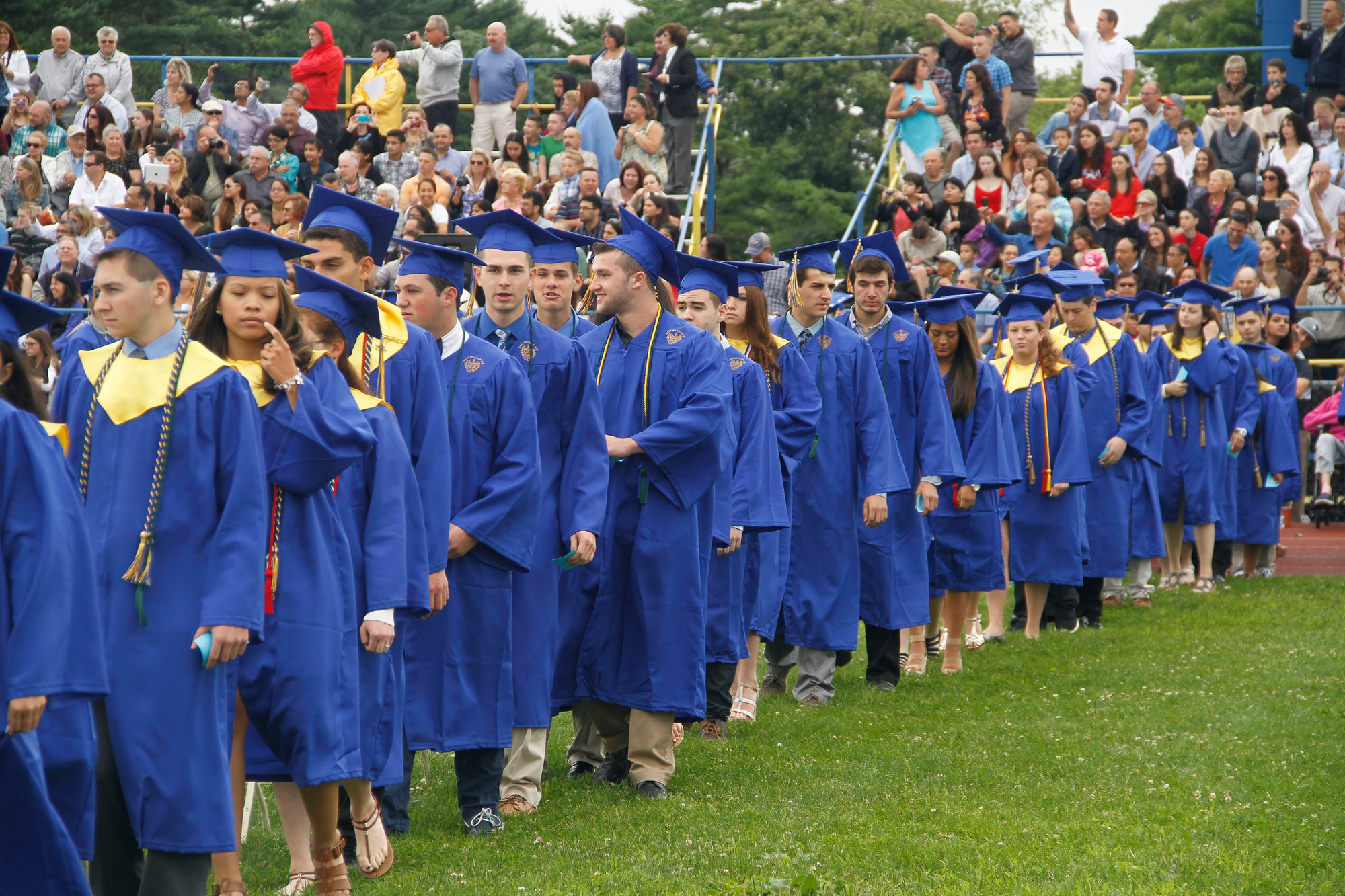 The seniors walked from the school to their graduation ceremony, surrounded by hundreds of supporters.