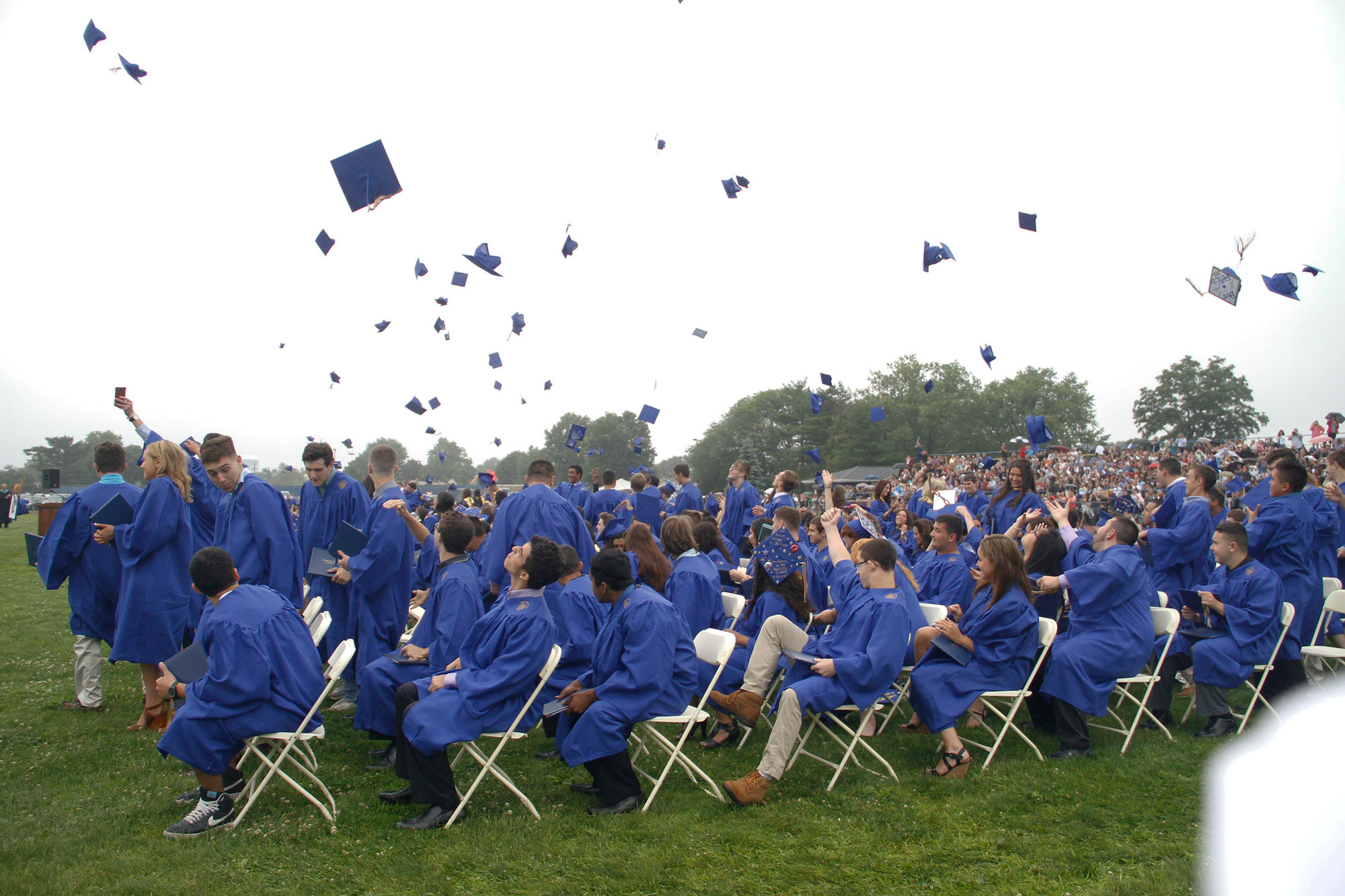 The tossing of the mortarboards marked the end of Sunday’s ceremony on the East Meadow High School football field.