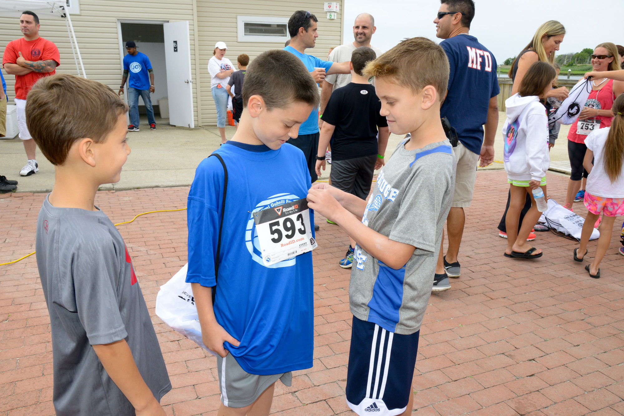 Getting a number pinned on, Christian Luca age, 7, Nicholas Colon, 8, Mario Hroncich, 9 at the Gubelli Race/Walk 2015.