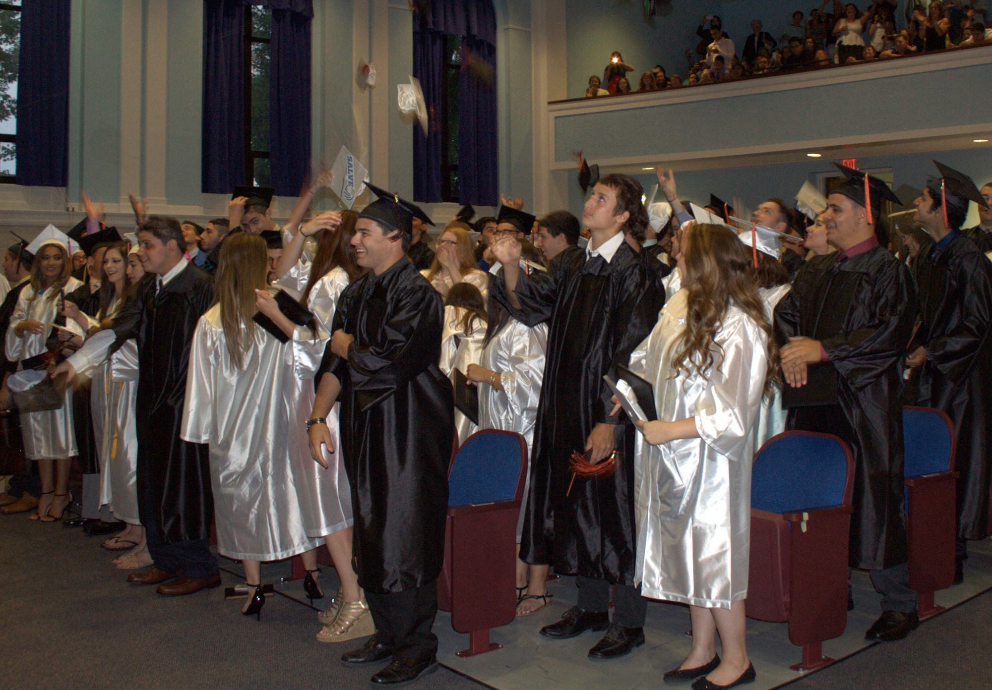 The just-pronounced graduates tossed their caps in the air.