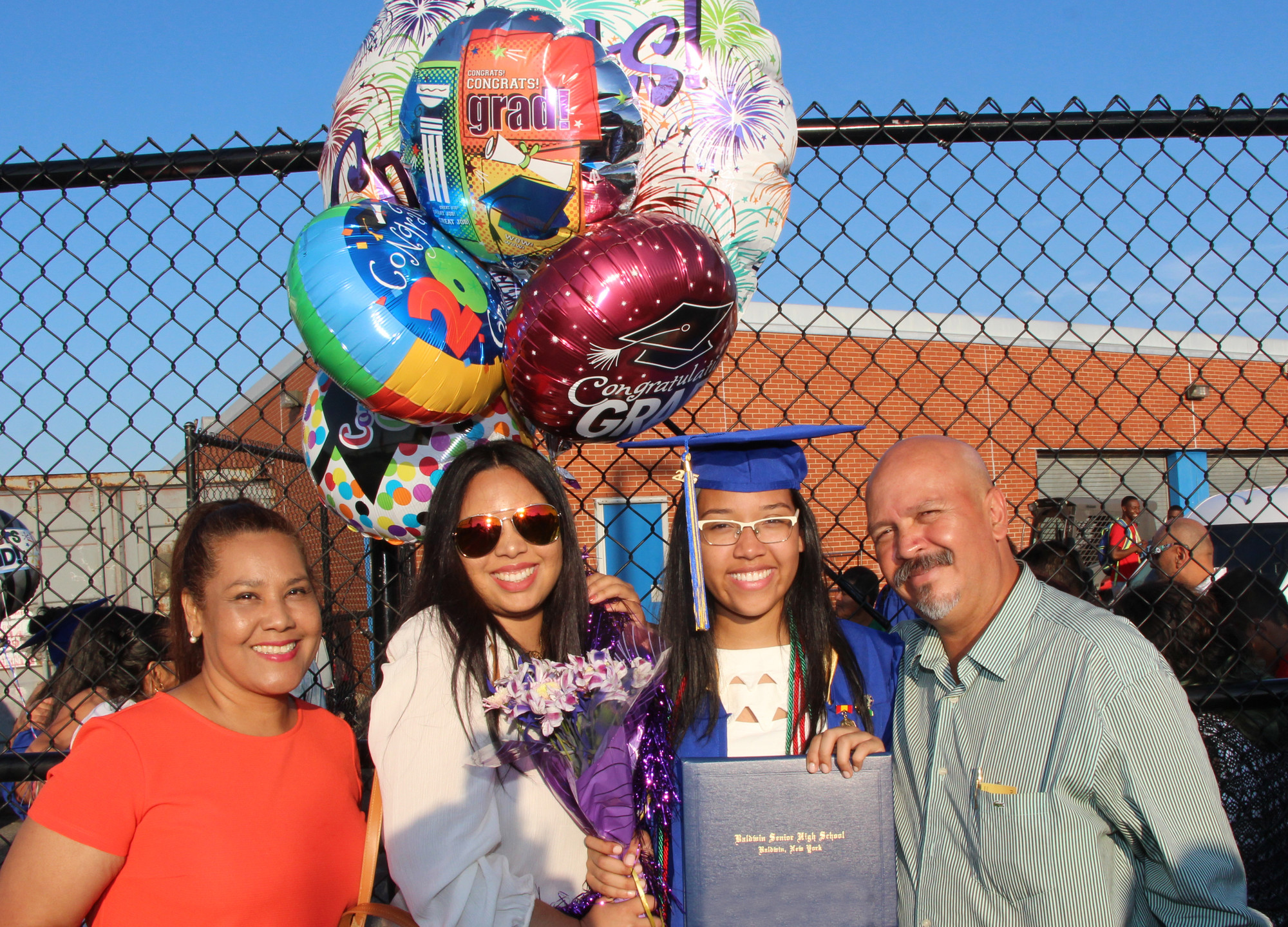 Graduate Elisa Nunez celebrated with her mother, Anna, far left, her sister, Stephanie, and her father, Mario.