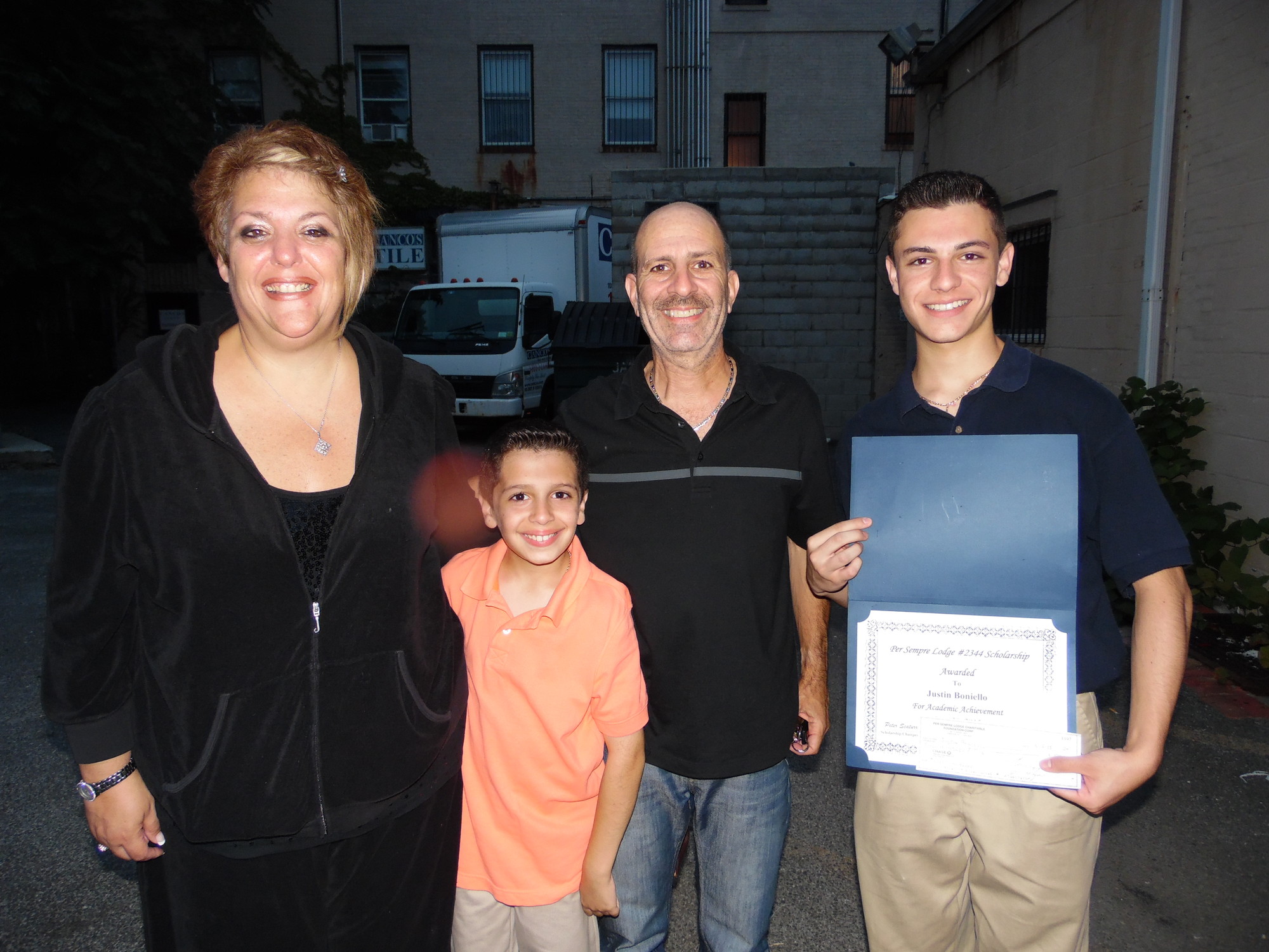 Scholarship winner Justin Boniello, right, was congratulated by his family after the ceremony. His mother, Michelle, is at left, his father, Claude, next to Justin, and his little brother, Joseph.