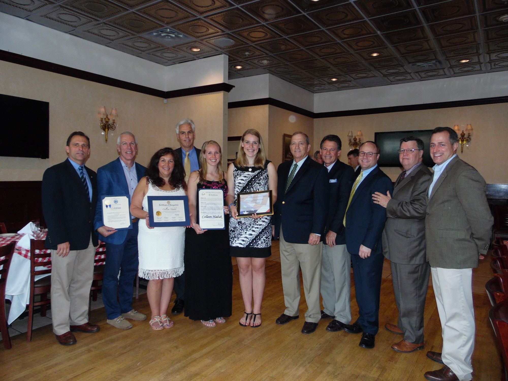 Scholarship winner Colleen Hudak was congratulated by her family and others. Pictured from left were the Frank J. Becker Educational Foundation president Hillary Becker, Kenneth Jones, Janey Vuturo, Edward Hudak, sister Michelle, Colleen, Lynbrook Village Justice William McLaughlin, Legislator Francis Becker, Ari Fertig, Mayor Bill Hendrick, and Assemblyman Brian Curran.