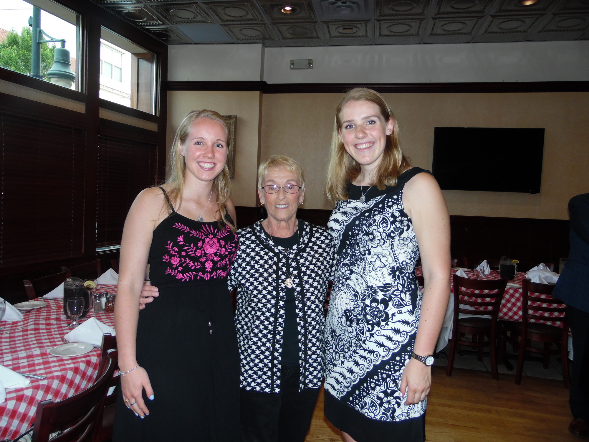 Peggy Becker, center, also a Sacred Heart alumna, congratulated Colleen, right. They are pictured with Colleen’s sister, Michelle, at left.