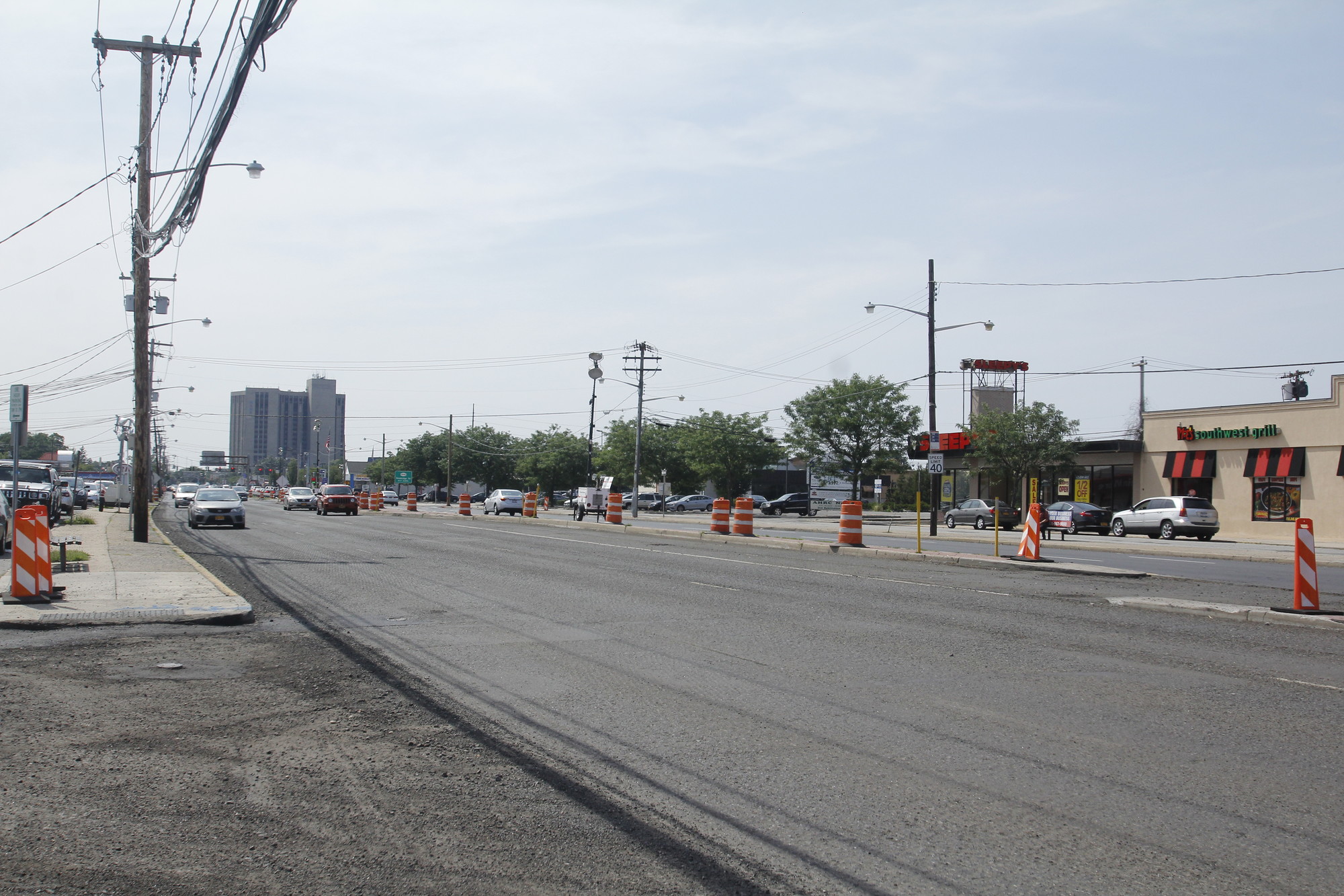 The Repaving of Hempstead Turnpike by the state Department of Transportation began in mid-May. At left, an unfinished eastbound section near the Wantagh Parkway.