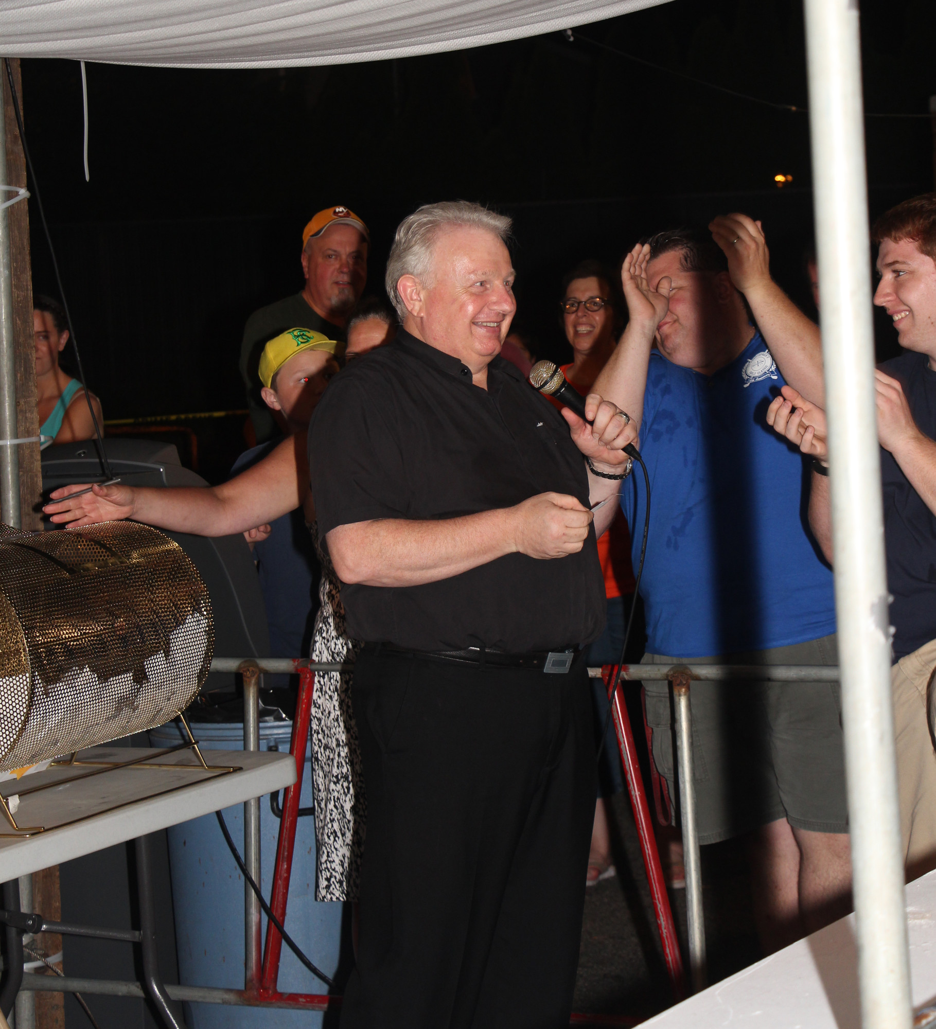 Msgr. Steven Camp picked raffle tickets as the large crowd looked on with anticipation.