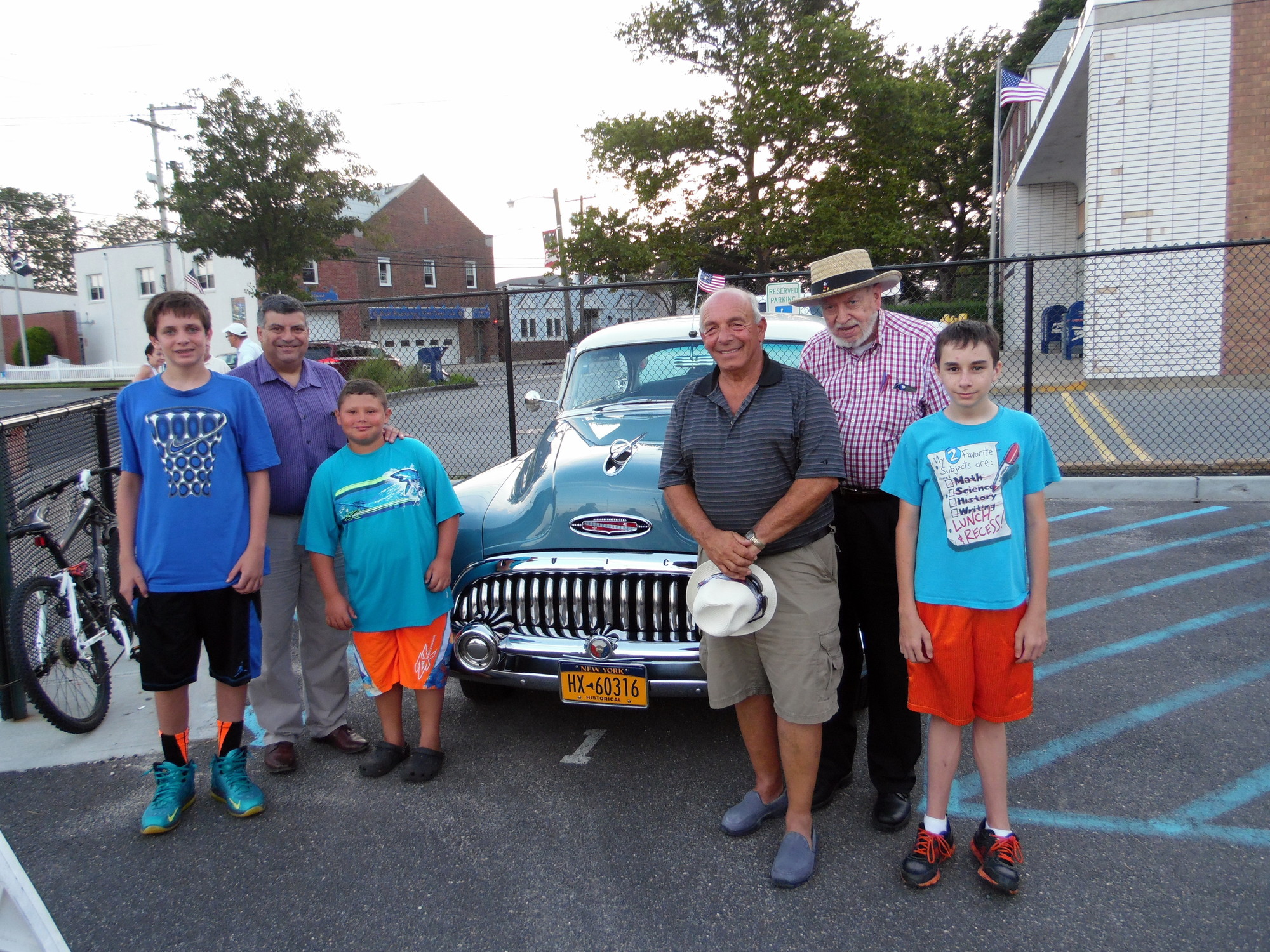 Car show coordinator Rich Cittadino, third from right, welcomed his helpers, local officials, and members of the East Rockaway Education Foundation. With him in front of a Buick Special Riviera were, from left, Matt Miller, 14, Mayor Bruno Romano and his 9-year-old son, Joseph, EREF President Richard Meagher, and Scott Buzzolani, 14, The boys helped put together the raffle baskets.