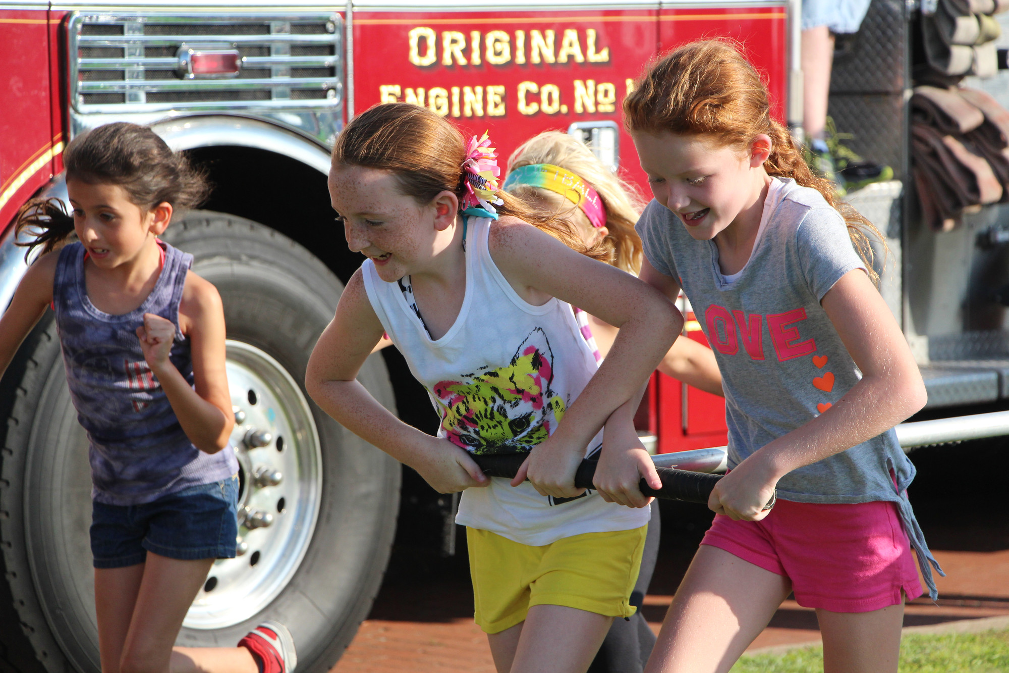 Sophia Cerreto, Colleen Reichel, Paige Perrone, all 9 years old, race to the “fire”.