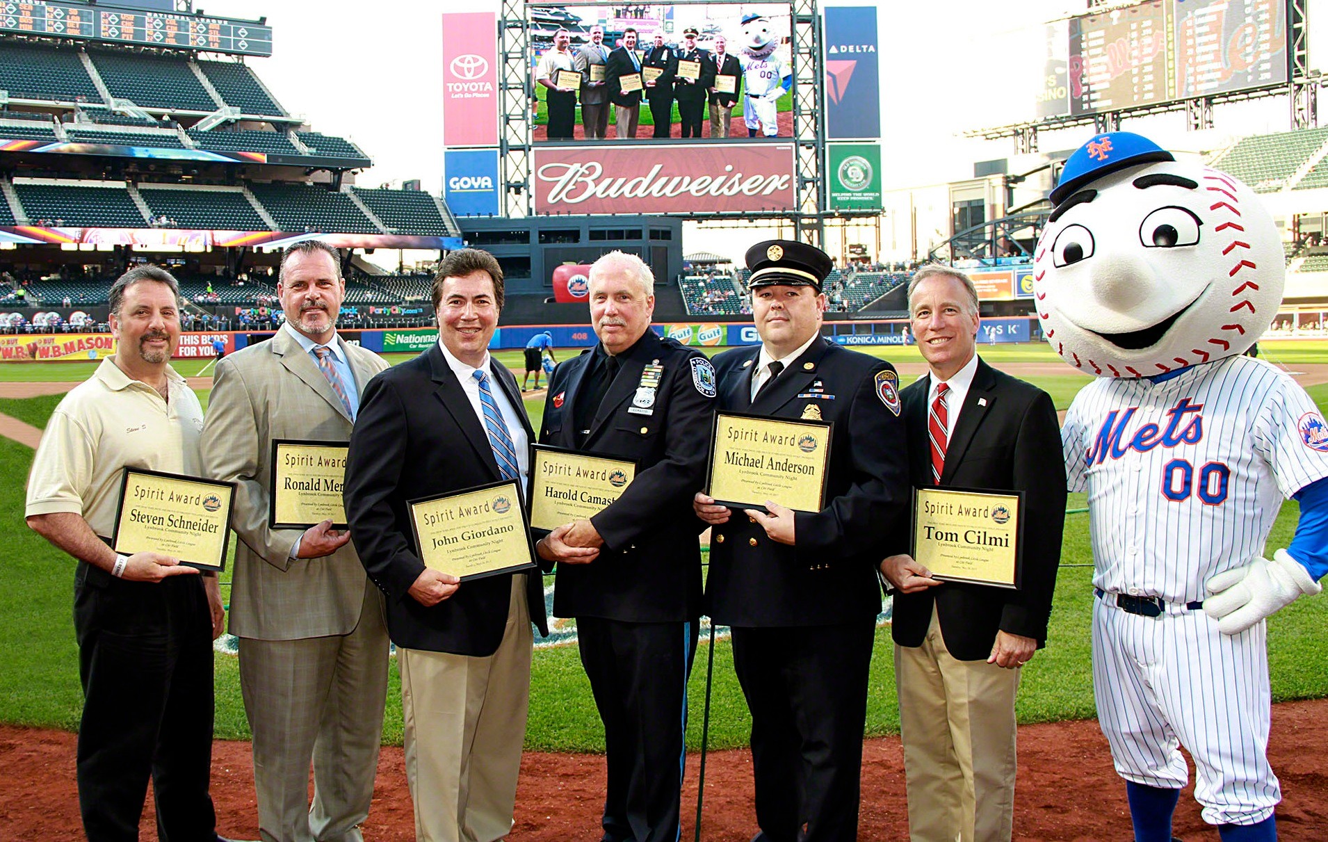 The Lynbrook community spirit award ceremony was held at Citi Field. Pictured from left were Little league Manager Steve Schneider, Ronald Merrow of Sunrise Volkswagen, Village Administrator John Giordano, Police Officer Harold Comastri, Fire Department Ex-Chief Mike Andersen and Suffolk Legislator Tom Cilmi — and the Mets mascot, Mr. Met.