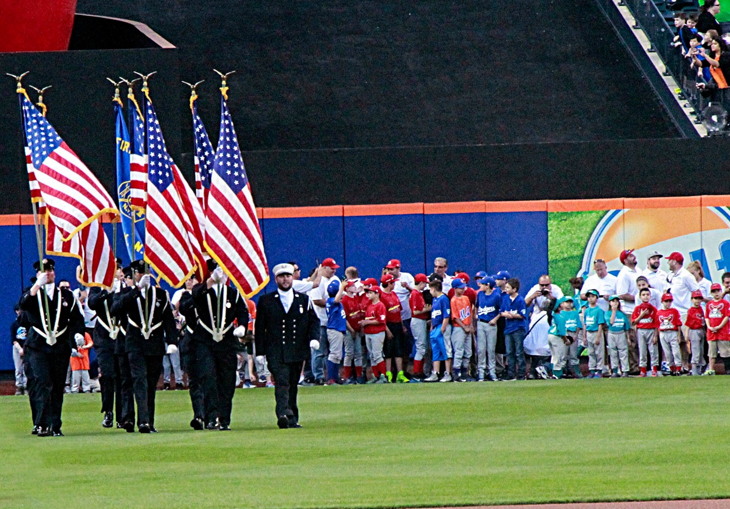 THe Lynbrook Fire Department’s Color Guard marched onto the field as the Little Leaguers watched.