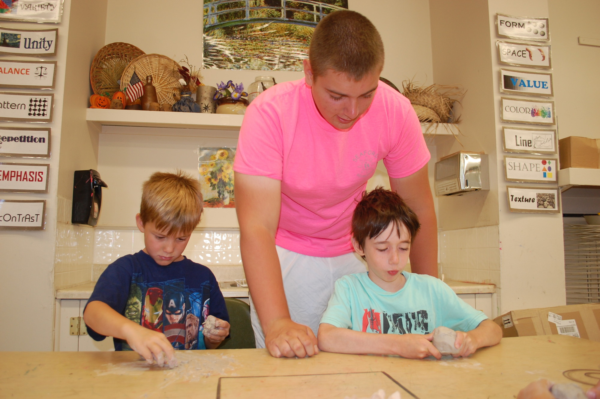 Christian Wendt, a recent Seaford High graduate, helped out Ryan Falta and Daniel Walsh, second graders at the Manor School, during arts and crafts.
