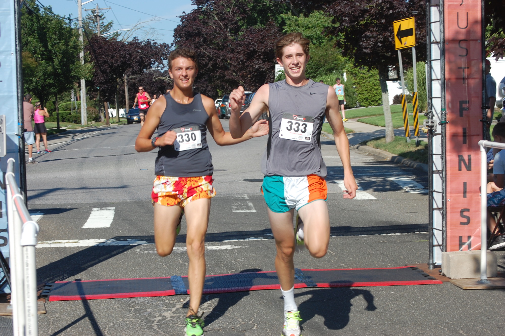 Wantagh track teammates Max Moritz, left, and James McVeigh crossed the finish line a hair apart at the Purple Ribbon Run on July 25.