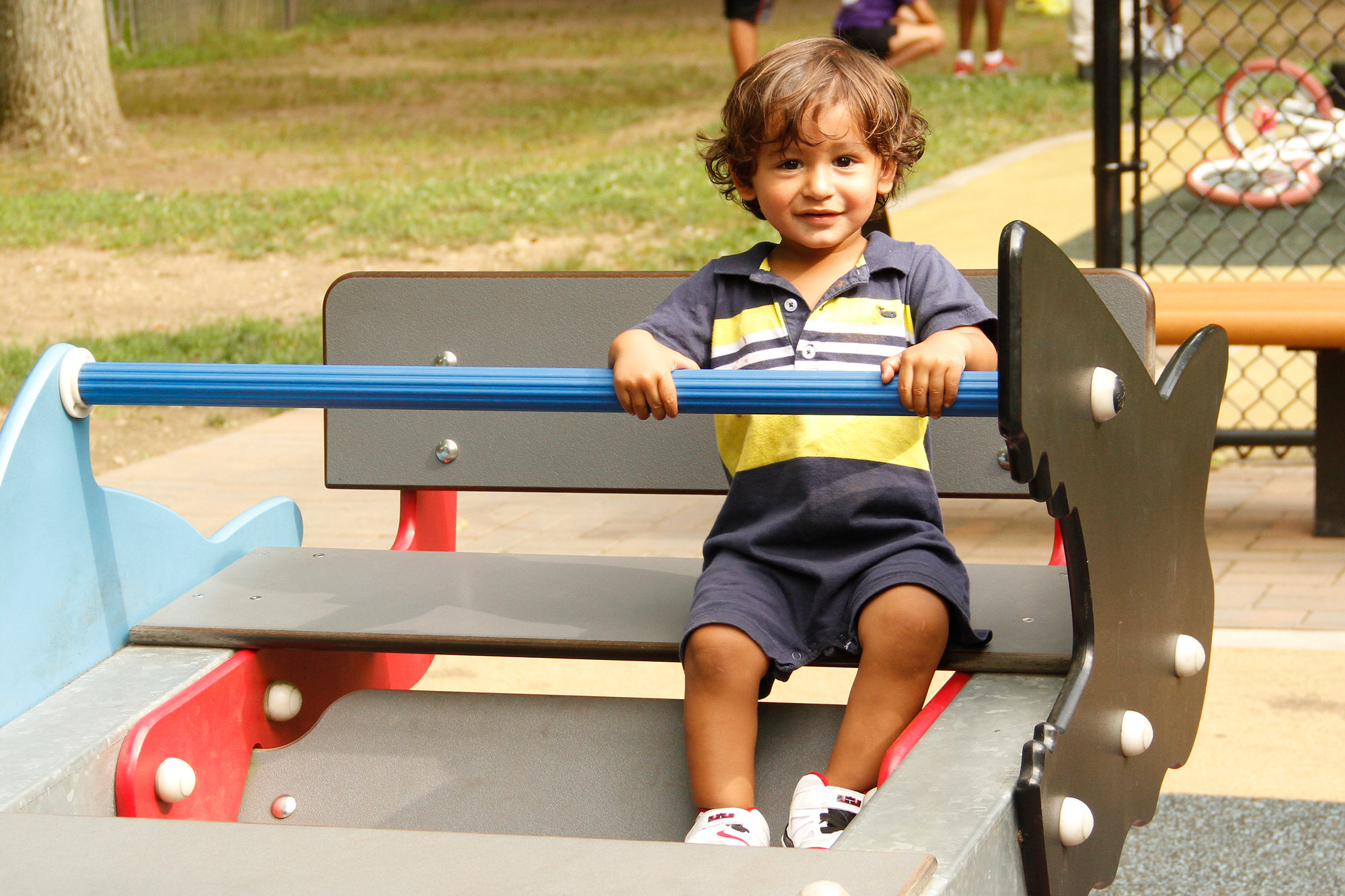 Jorge Escobar, 3, held tight to an adjustable entrance lever on one of the playground’s rides.