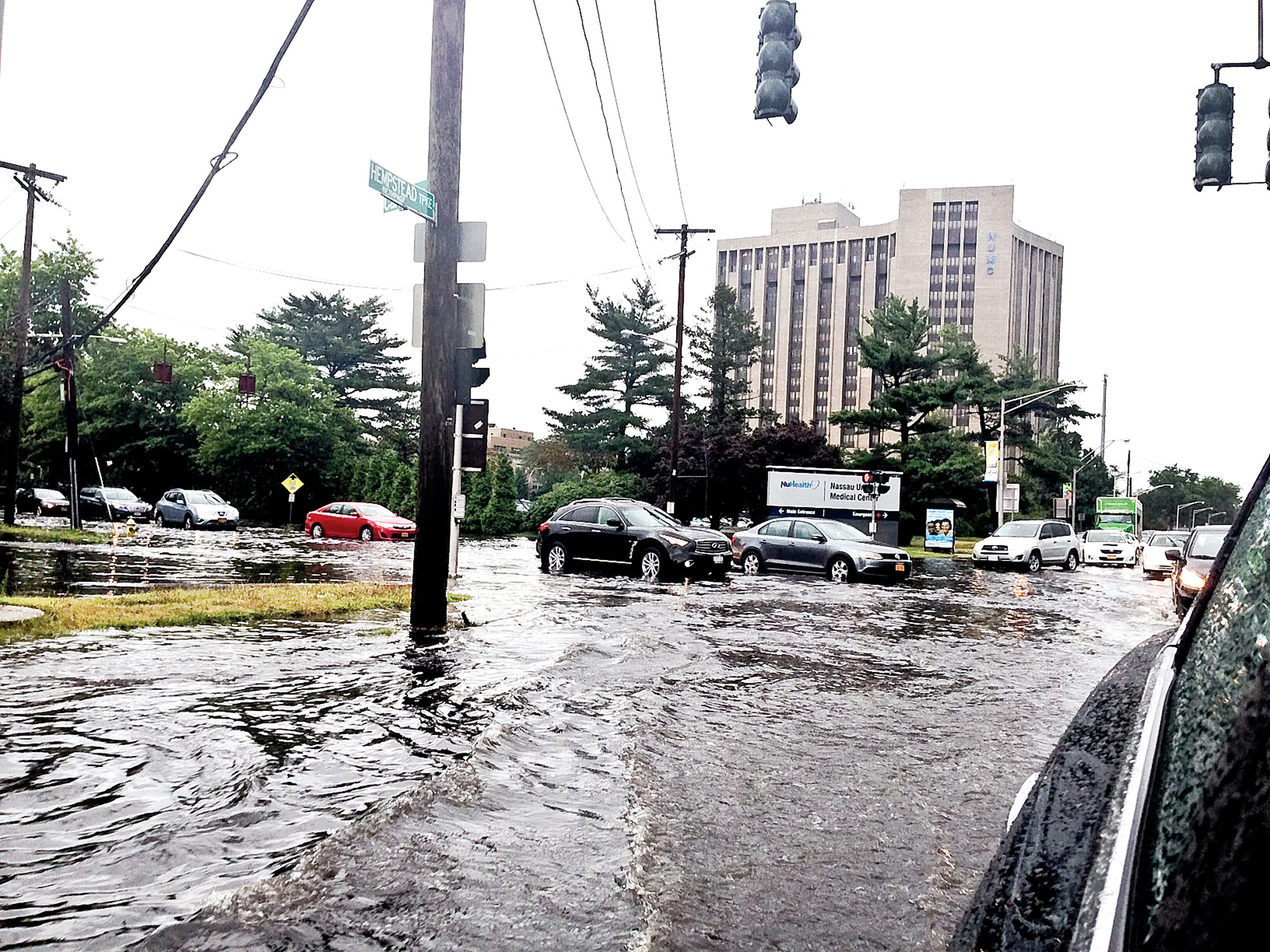 Rainfall inundated Hempstead Turnpike, at its intersection with Carman Avenue, on July 30.