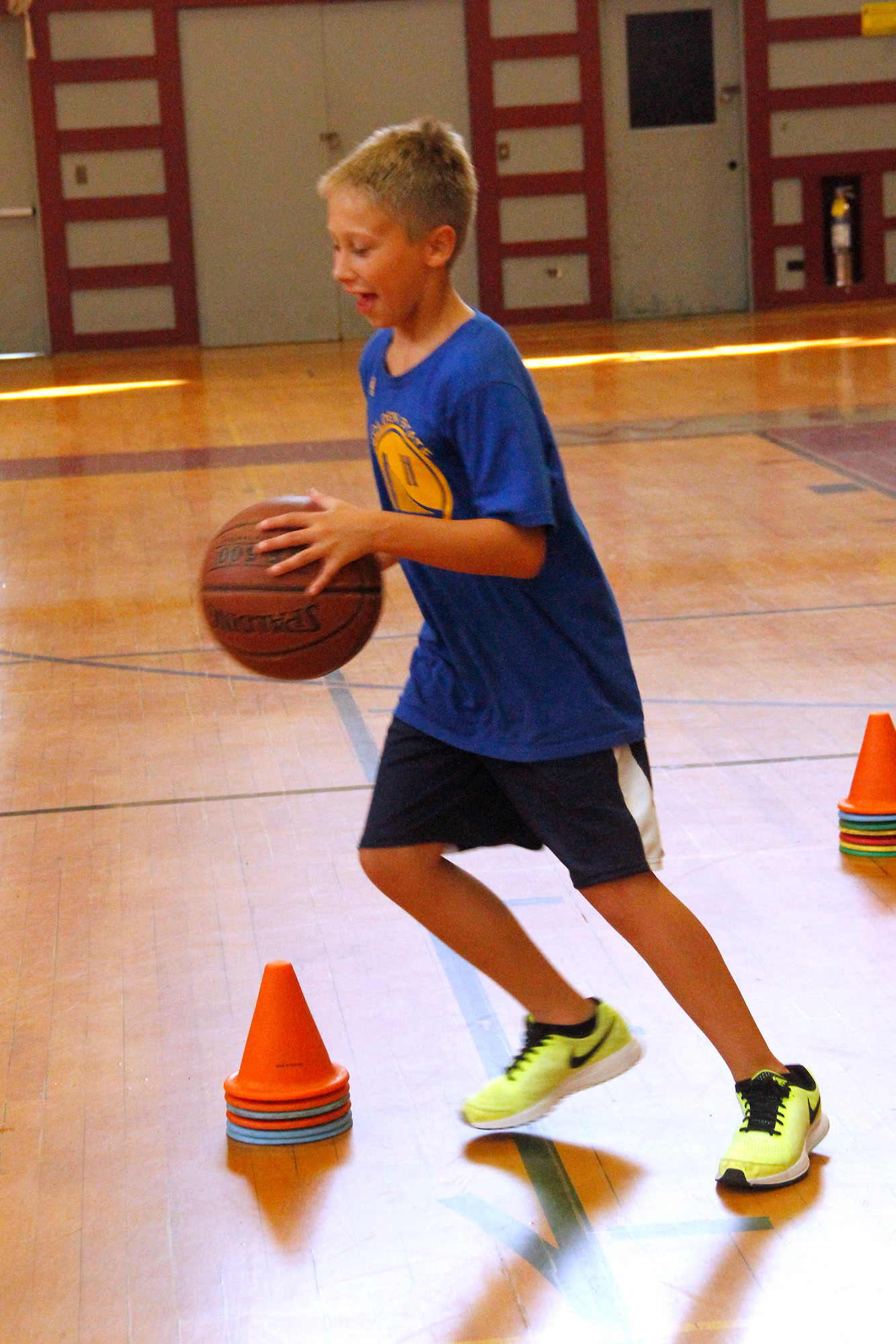 Sean Beitter worked on his dribbling skills. The students spent the hot day playing indoor sports in the air-conditioned gymnasium.